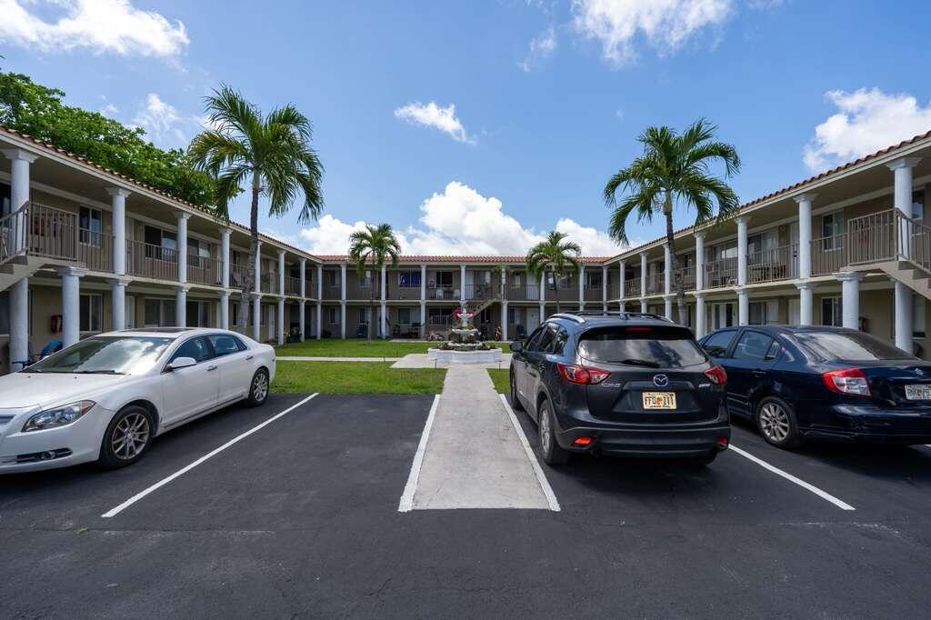 420 Northwest 10th Street, Unit 9 Miami, FL 33136 - Photo 13 of 14 a car parked in front of a house