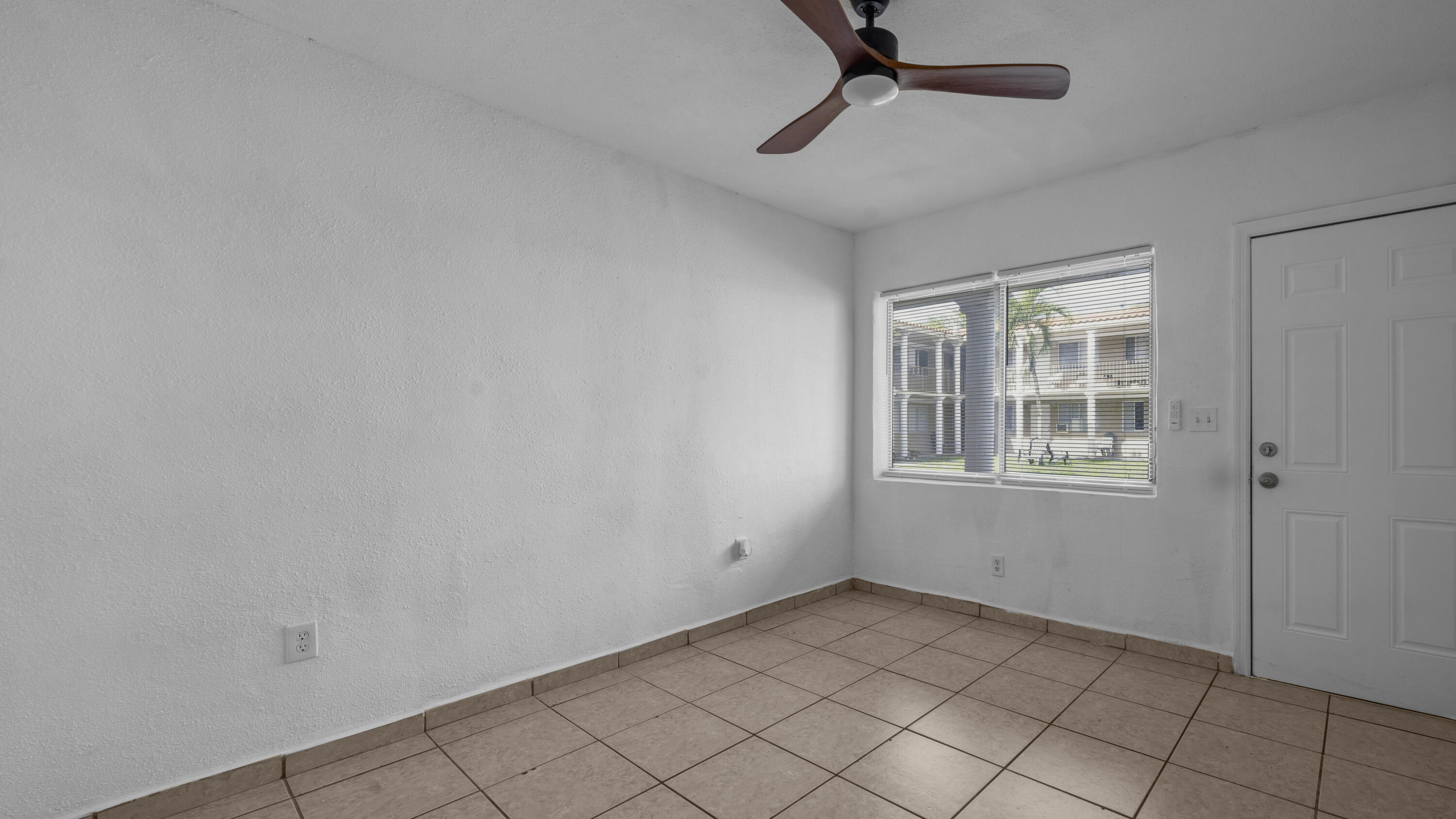 420 Northwest 10th Street, Unit 9 Miami, FL 33136 - Photo 4 of 14 a view of an empty room with a window