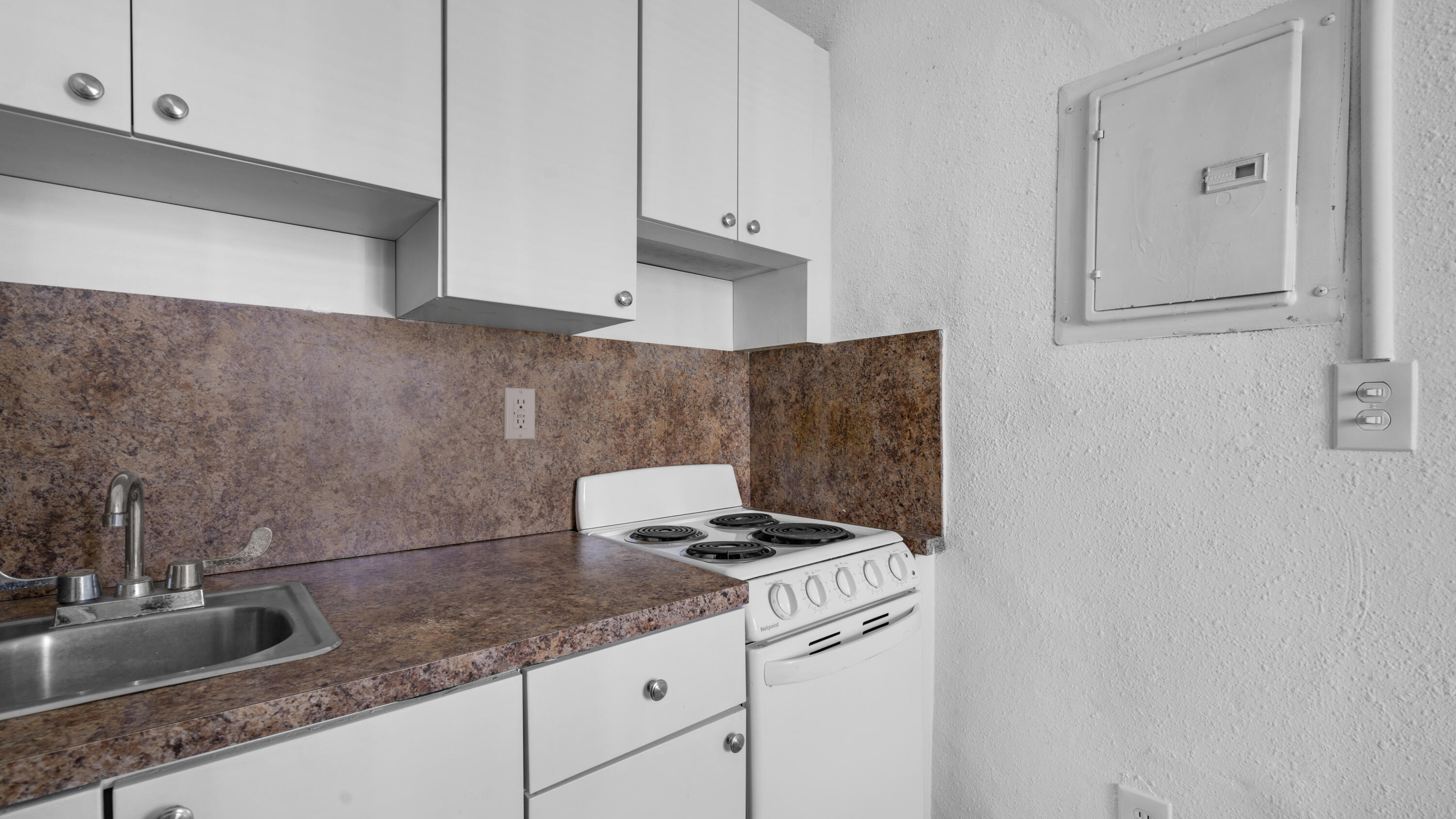 420 Northwest 10th Street, Unit 9 Miami, FL 33136 - Photo 6 of 14 a kitchen with granite countertop a sink and a stove