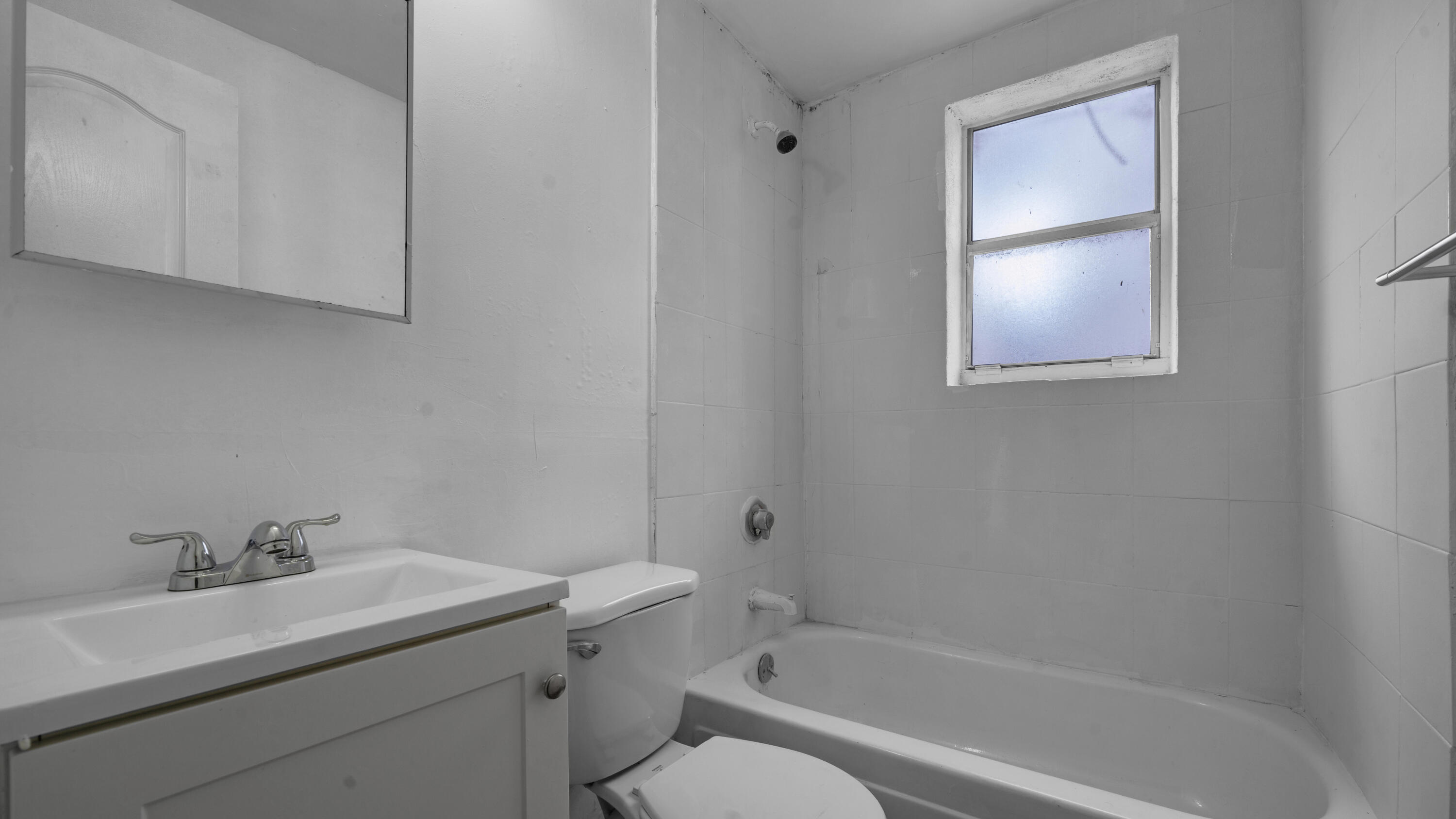 420 Northwest 10th Street, Unit 9 Miami, FL 33136 - Photo 7 of 14 a bathroom with a sink toilet and vanity