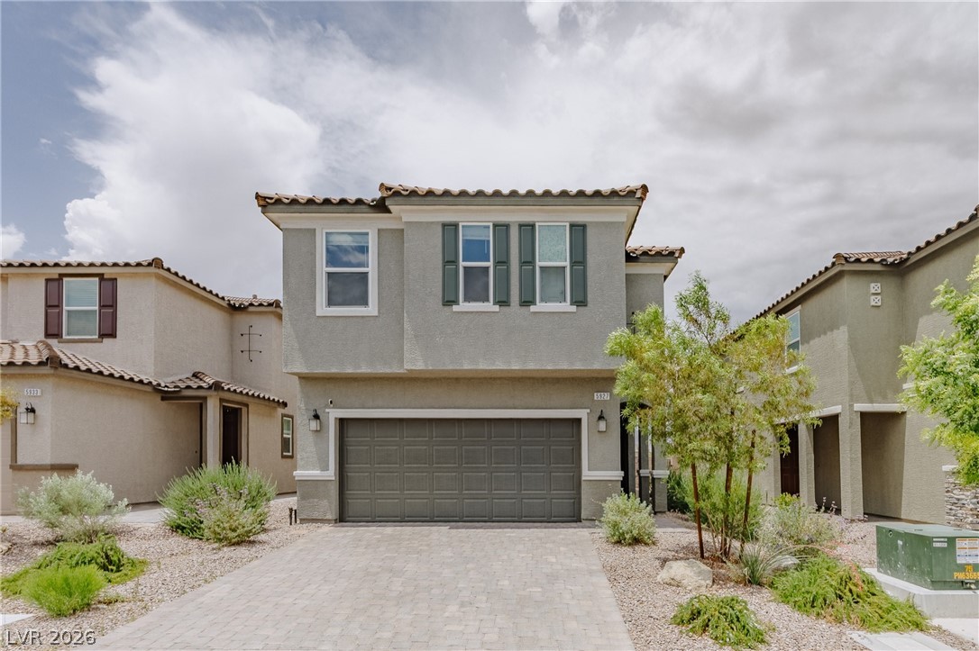 5927 Coja Street Las Vegas, NV 89113 - Photo 1 of 32 Mediterranean / spanish house with stucco siding, decorative driveway, an attached garage, and a tiled roof
