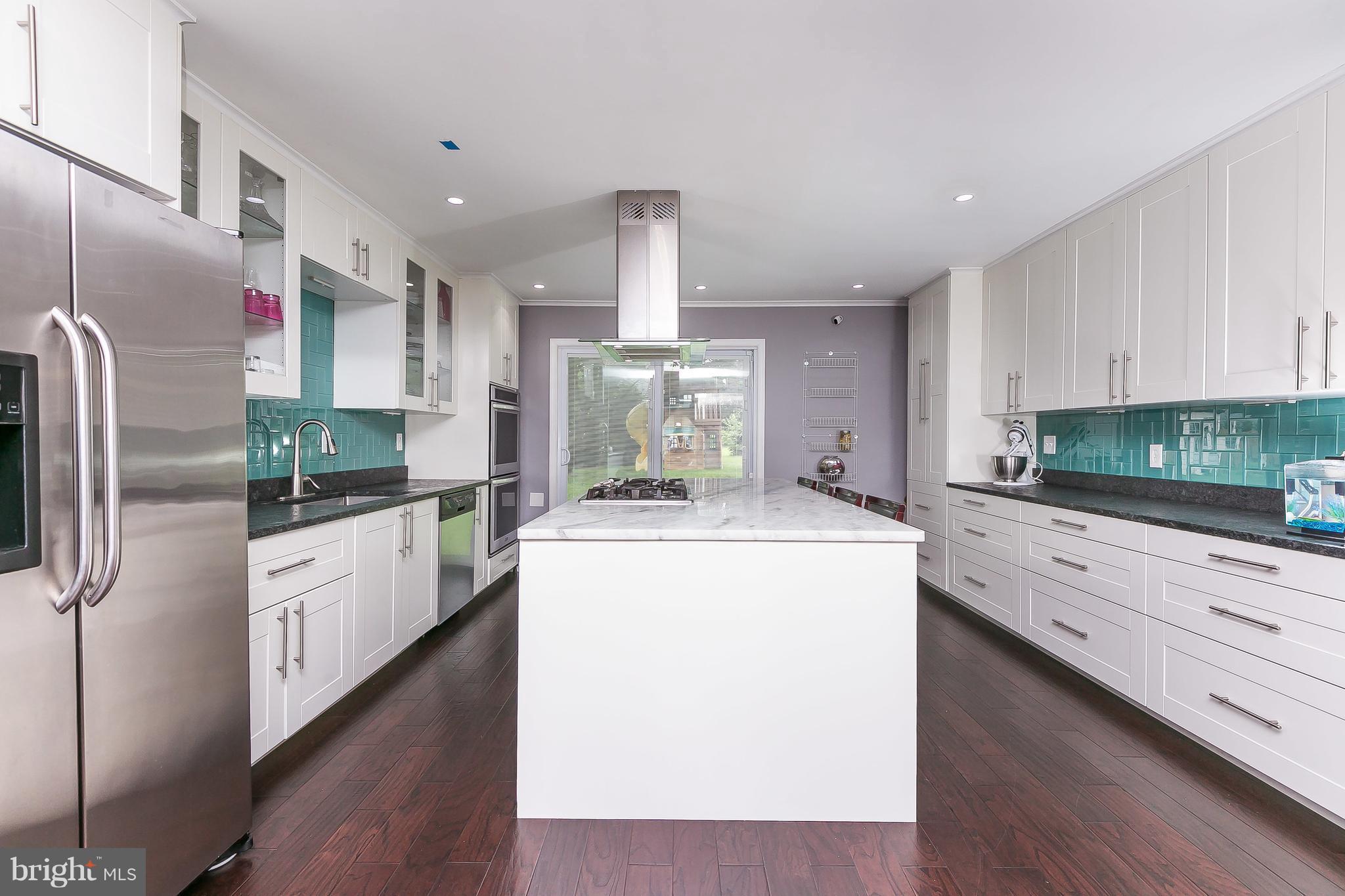 10 Harding Street Lutherville-Timonium, MD 21093 - Photo 15 of 30 a kitchen with refrigerator cabinets and wooden floor