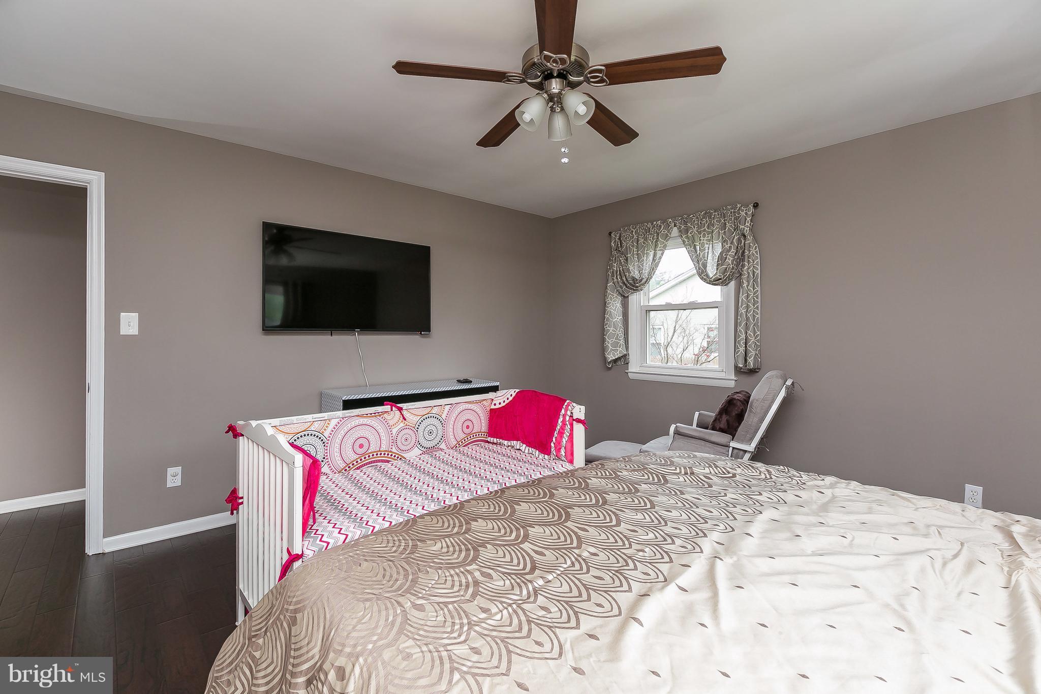 10 Harding Street Lutherville-Timonium, MD 21093 - Photo 22 of 30 a bedroom with a large bed and a flat screen tv