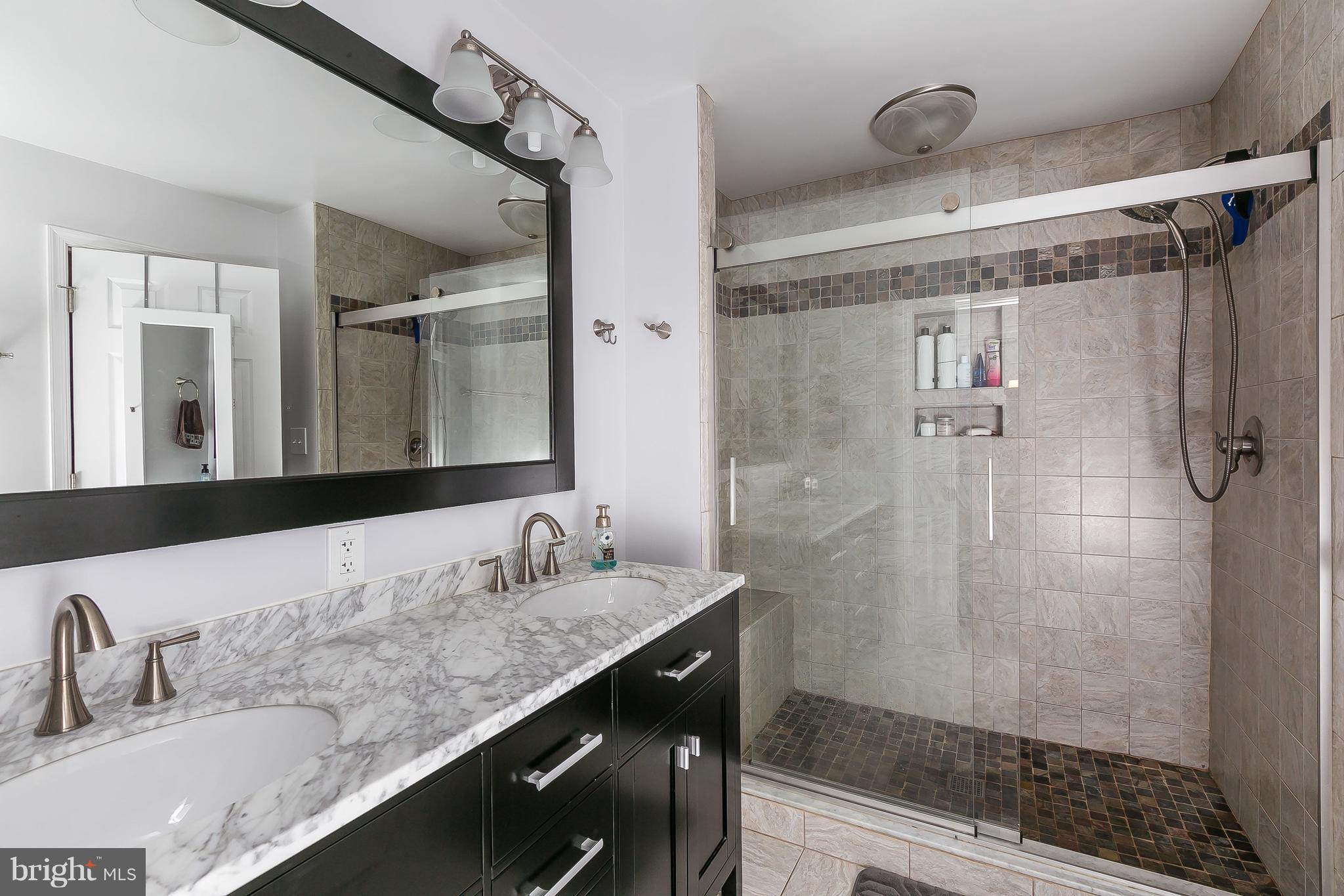 10 Harding Street Lutherville-Timonium, MD 21093 - Photo 23 of 30 a bathroom with a granite countertop shower sink and mirror