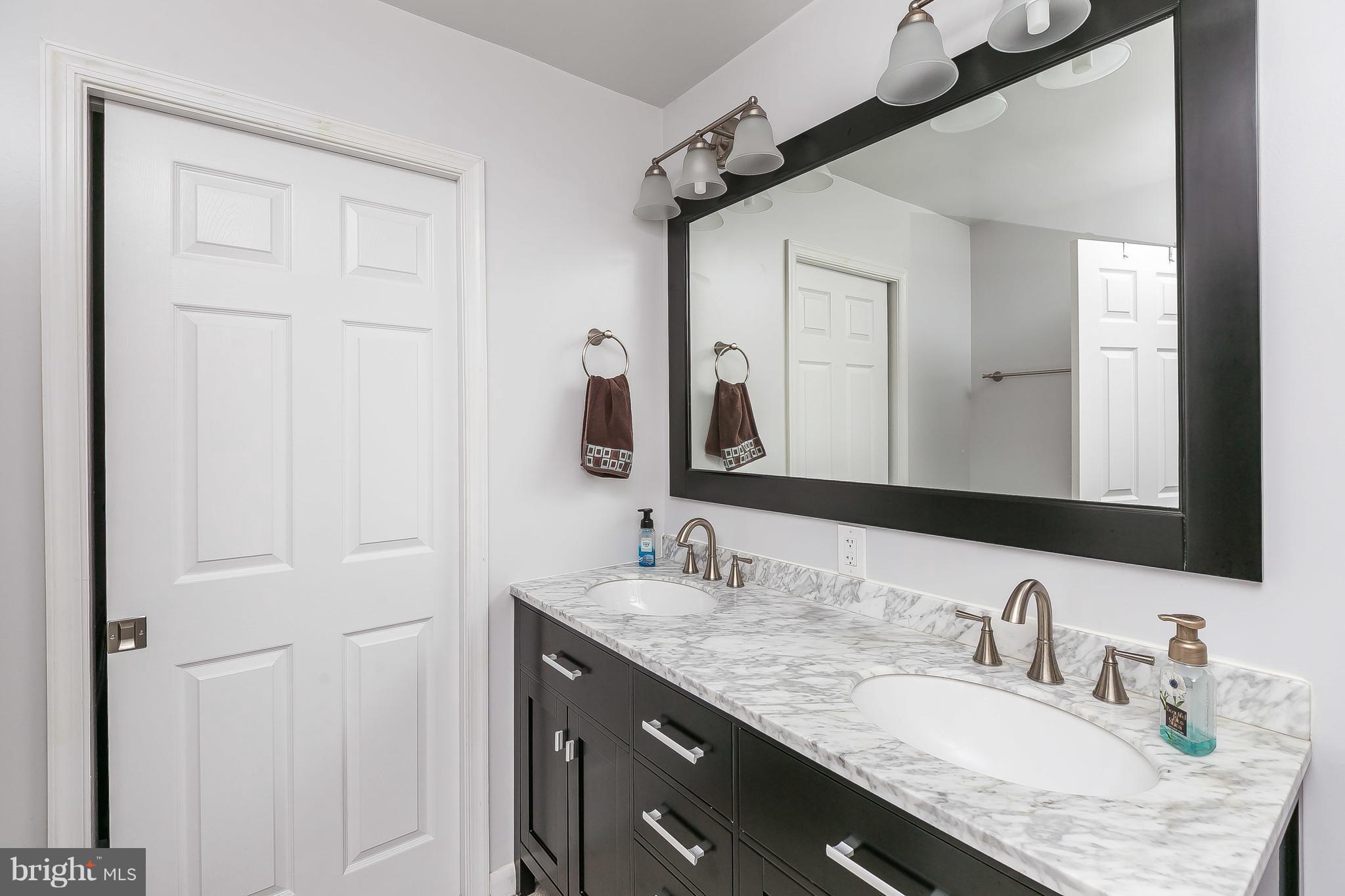10 Harding Street Lutherville-Timonium, MD 21093 - Photo 25 of 30 a bathroom with a granite countertop sink and a mirror
