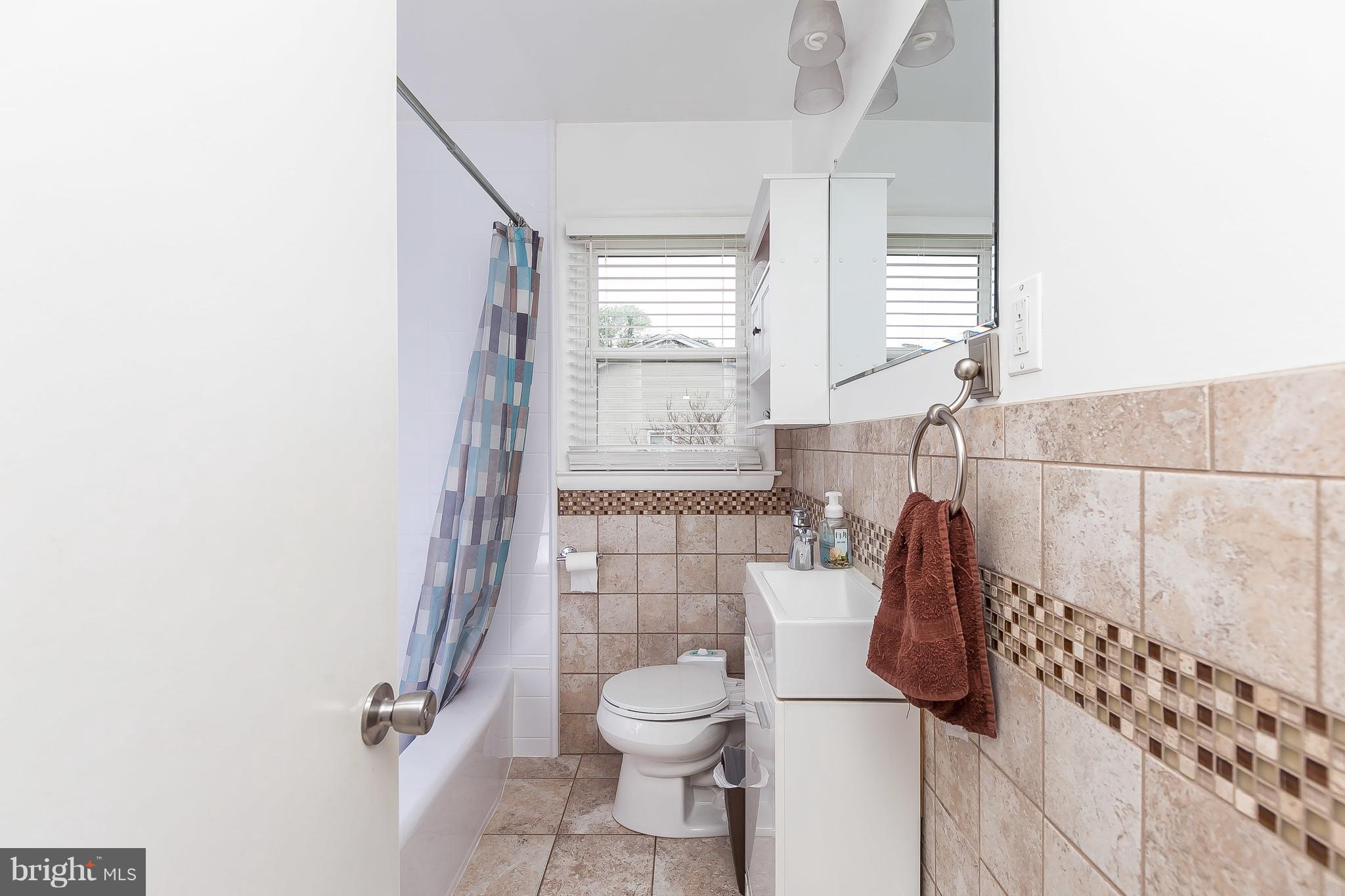 10 Harding Street Lutherville-Timonium, MD 21093 - Photo 30 of 30 a bathroom with a toilet and a shower curtain