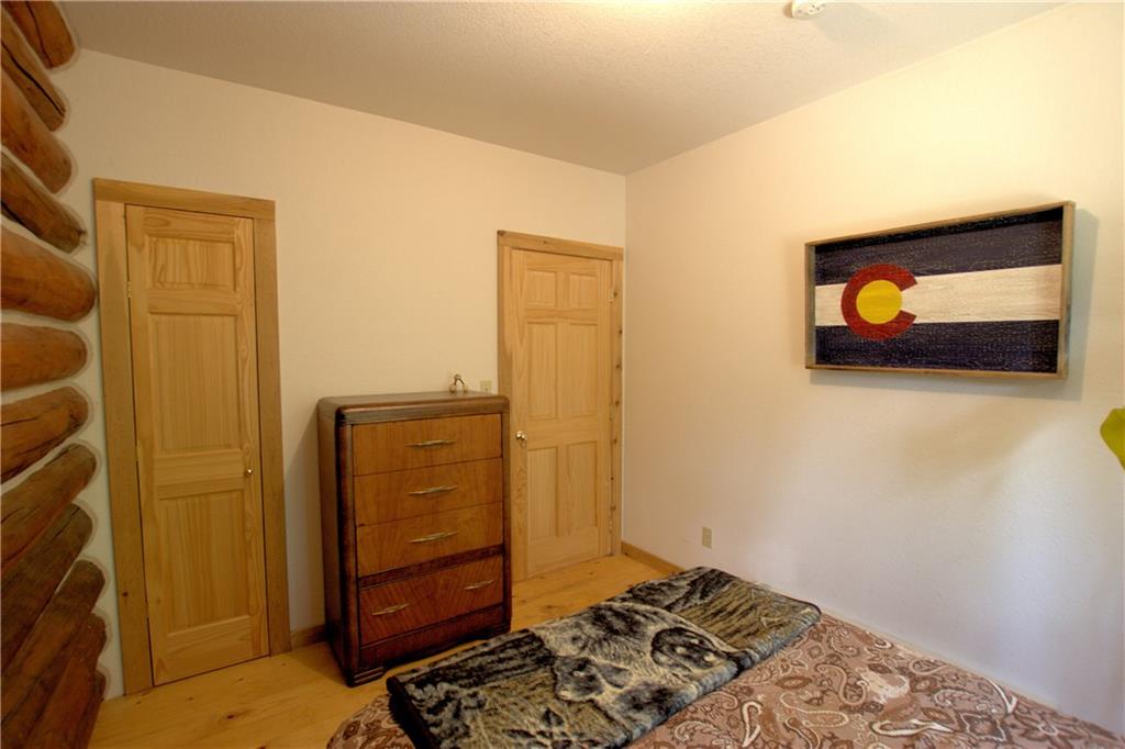 101 Rachaels Place Fairplay, CO 80440 - Photo 18 of 25 a bedroom with a bed and wooden floor
