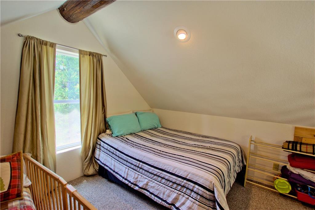 101 Rachaels Place Fairplay, CO 80440 - Photo 19 of 25 a bedroom with a bed and wooden floor