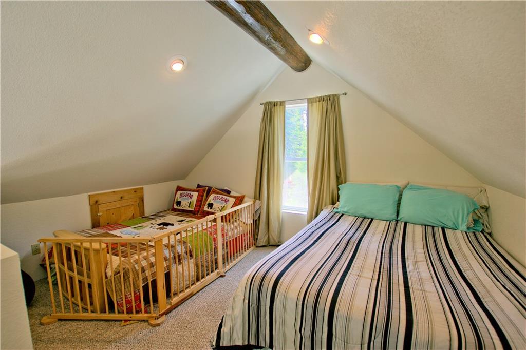 101 Rachaels Place Fairplay, CO 80440 - Photo 6 of 25 a bed sitting in a bedroom next to a window