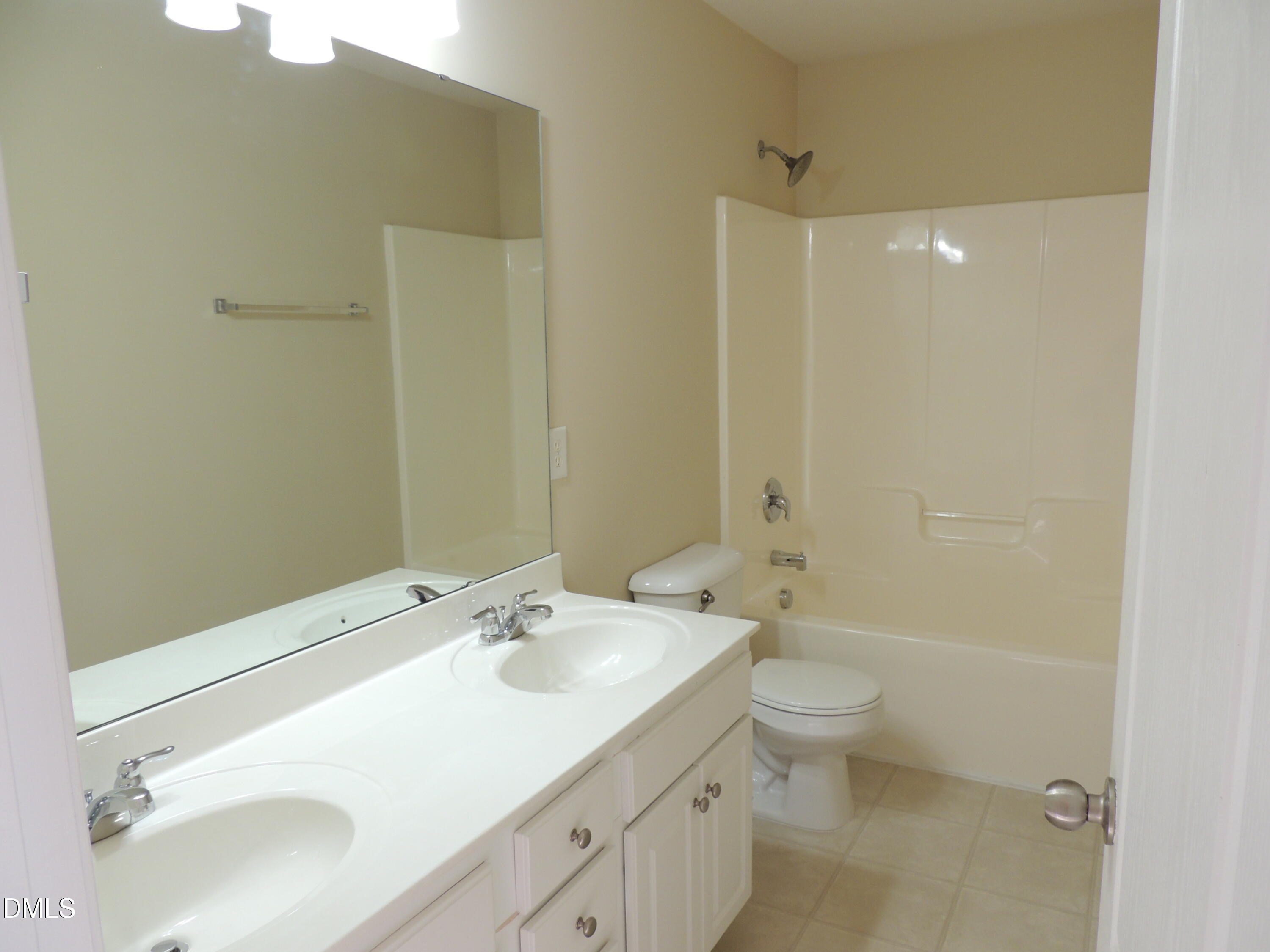 12544 Honeychurch Street Raleigh, NC 27614 - Photo 18 of 24 a bathroom with a sink a toilet and shower