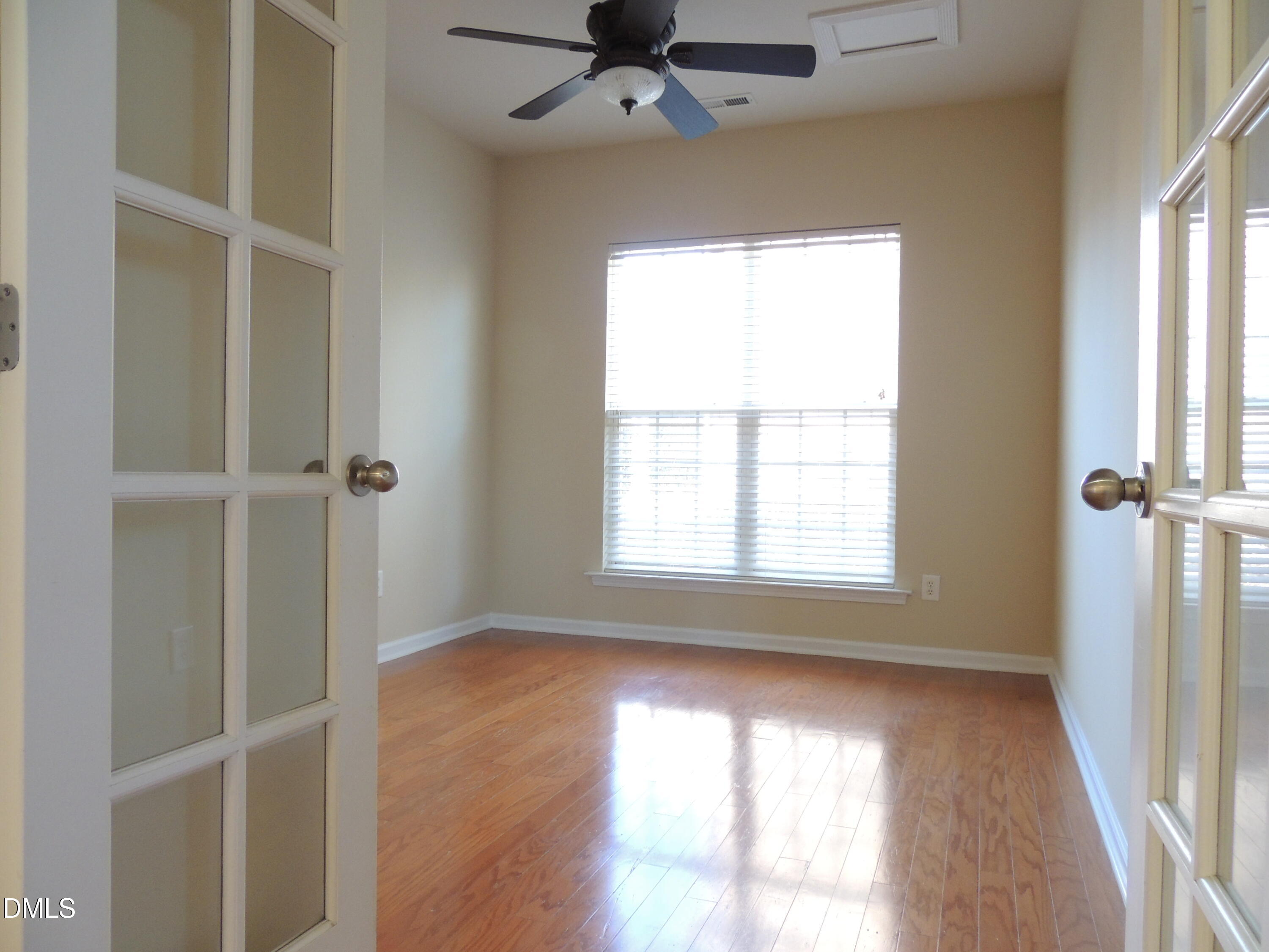 12544 Honeychurch Street Raleigh, NC 27614 - Photo 8 of 24 a view of an empty room with a window and wooden floor