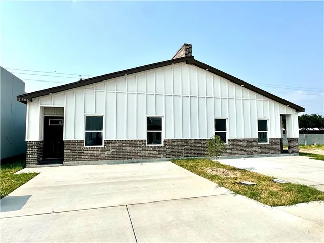 a view of a house with snow on the side of it