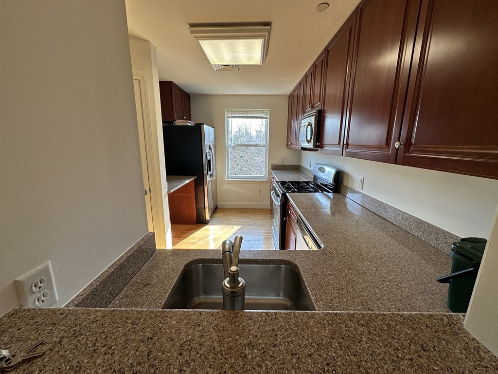 318 Rindge Avenue, Unit 216 Cambridge, MA 02140 - Photo 5 of 15 a view of a living room and bathroom