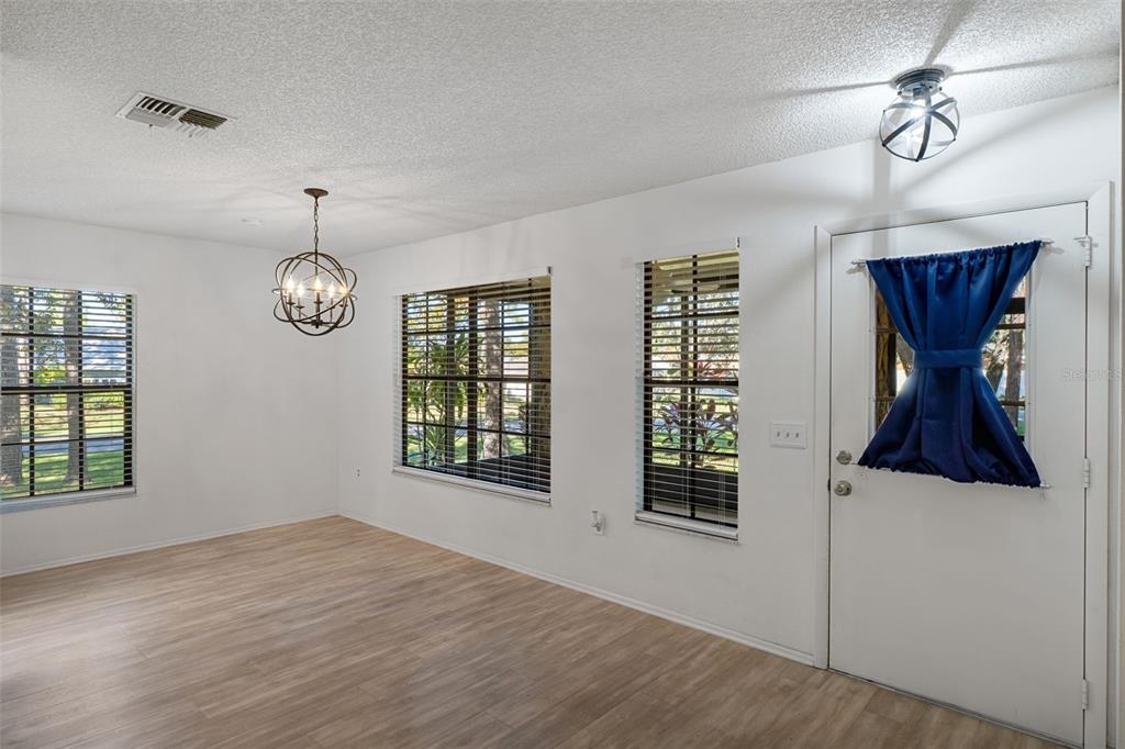 2129 Point O Woods Court Spring Hill, FL 34606 - Photo 11 of 76 a view of an empty room with wooden floor and fan
