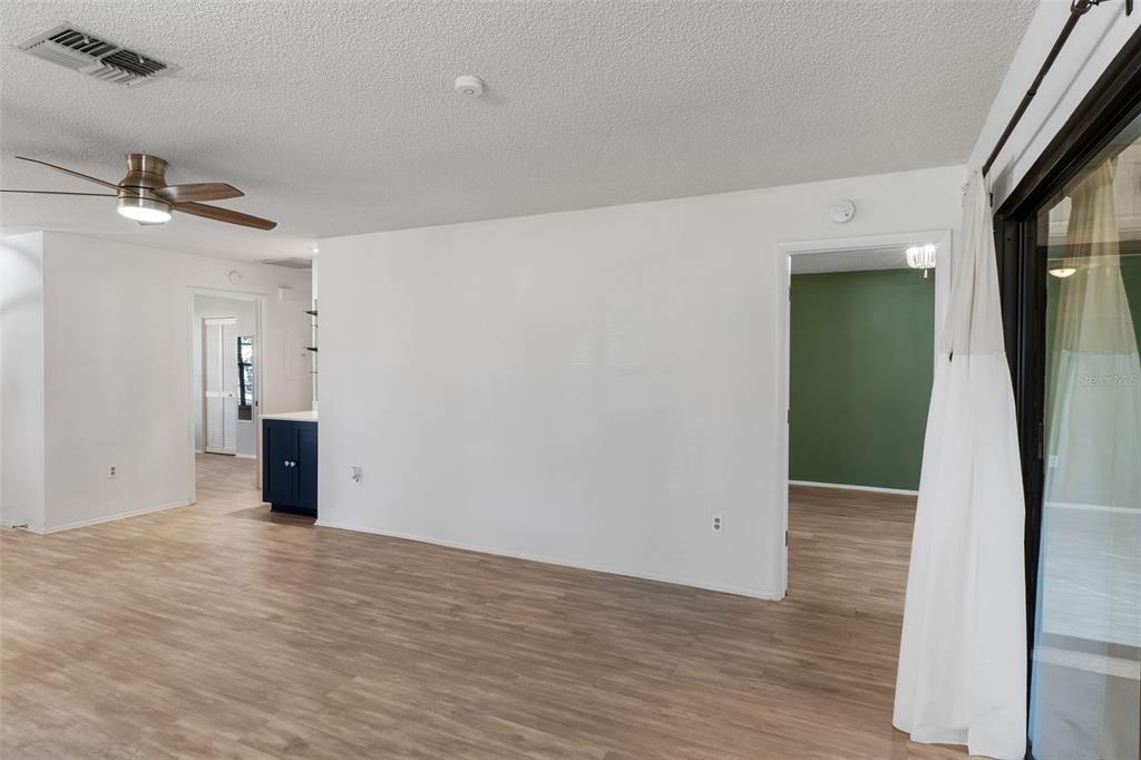 2129 Point O Woods Court Spring Hill, FL 34606 - Photo 14 of 76 a view of a big room with wooden floor and windows