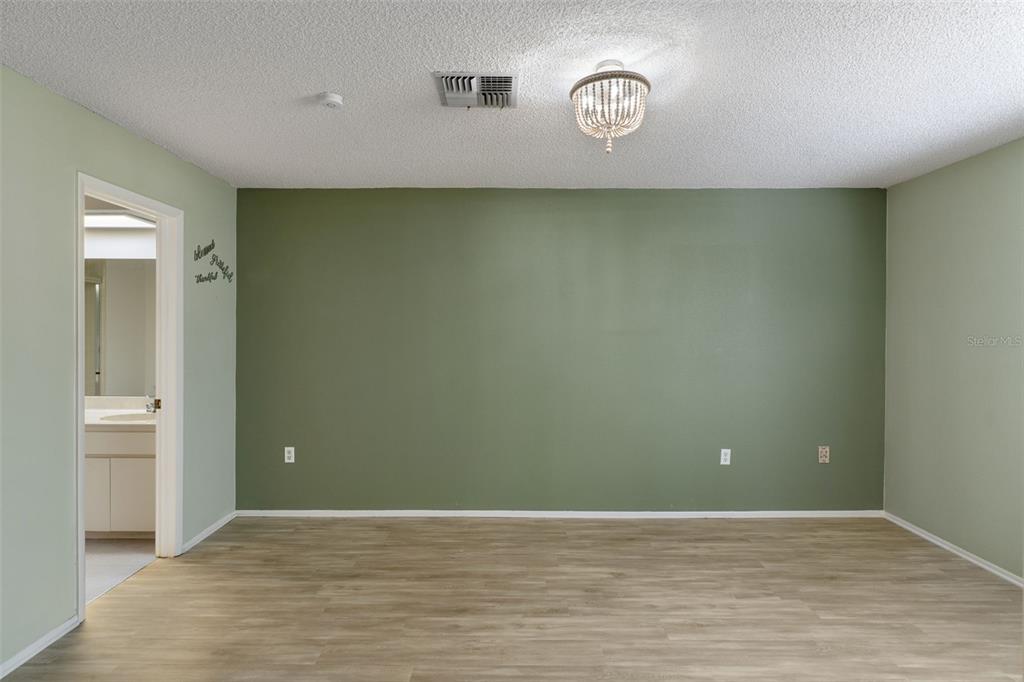 2129 Point O Woods Court Spring Hill, FL 34606 - Photo 16 of 76 a view of an empty room with wooden floor and a window