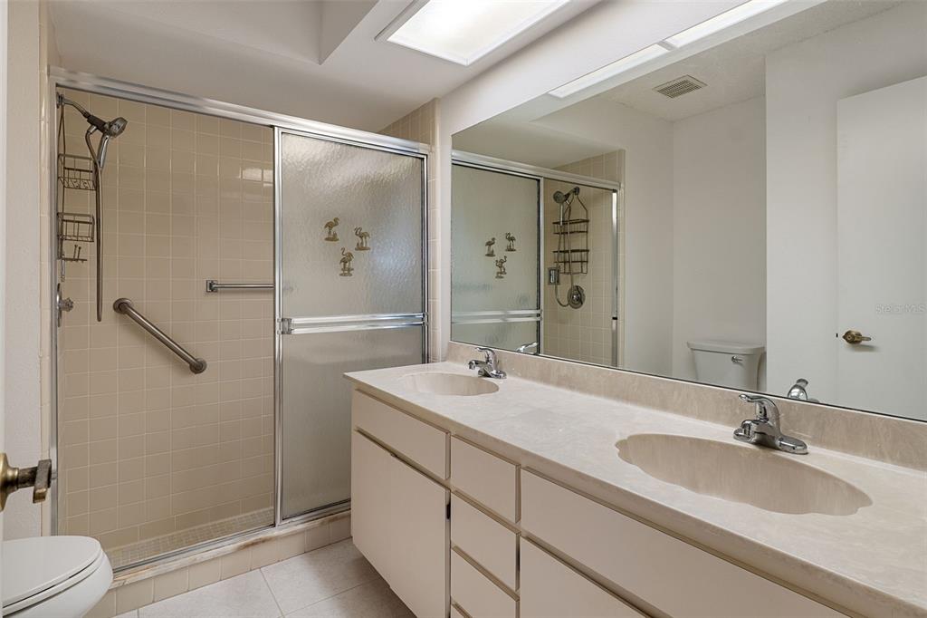2129 Point O Woods Court Spring Hill, FL 34606 - Photo 18 of 76 a bathroom with a double vanity sink mirror double and shower