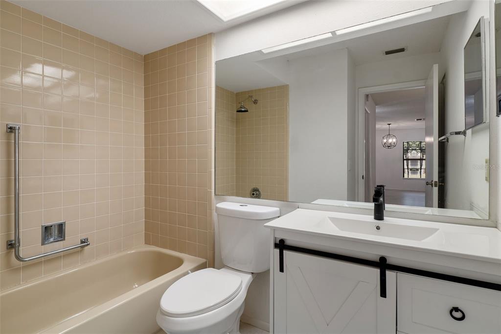 2129 Point O Woods Court Spring Hill, FL 34606 - Photo 21 of 76 a bathroom with a sink a toilet and shower