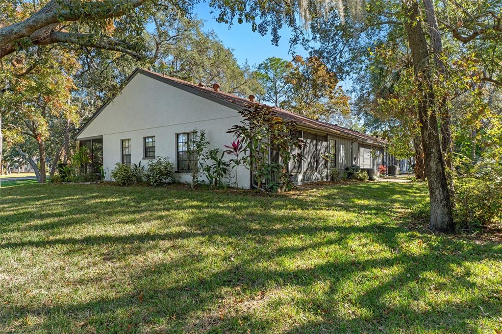 2129 Point O Woods Court Spring Hill, FL 34606 - Photo 25 of 76 a front view of house with yard and green space