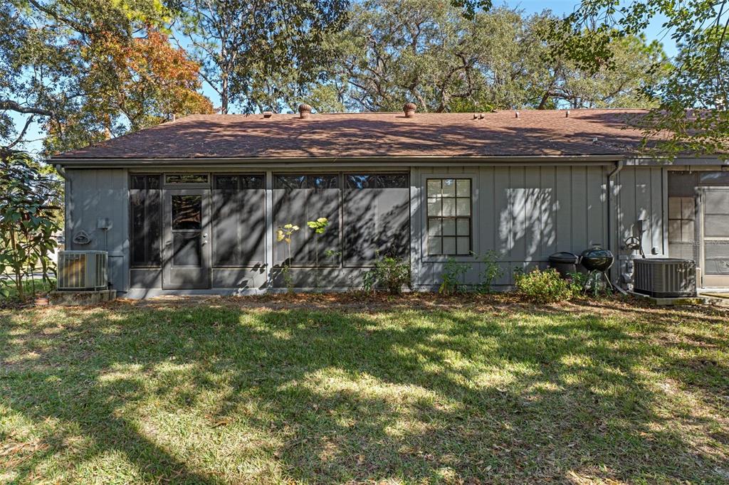 2129 Point O Woods Court Spring Hill, FL 34606 - Photo 27 of 76 a view of a house with a small yard and plants