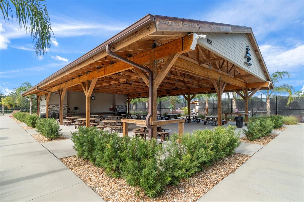 2129 Point O Woods Court Spring Hill, FL 34606 - Photo 60 of 76 a view of a chair and tables in the patio