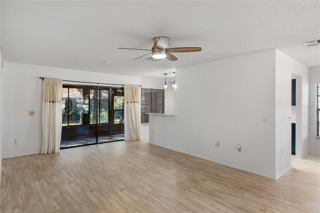 2129 Point O Woods Court Spring Hill, FL 34606 - Photo 6 of 76 a view of an empty room with a window and a kitchen view