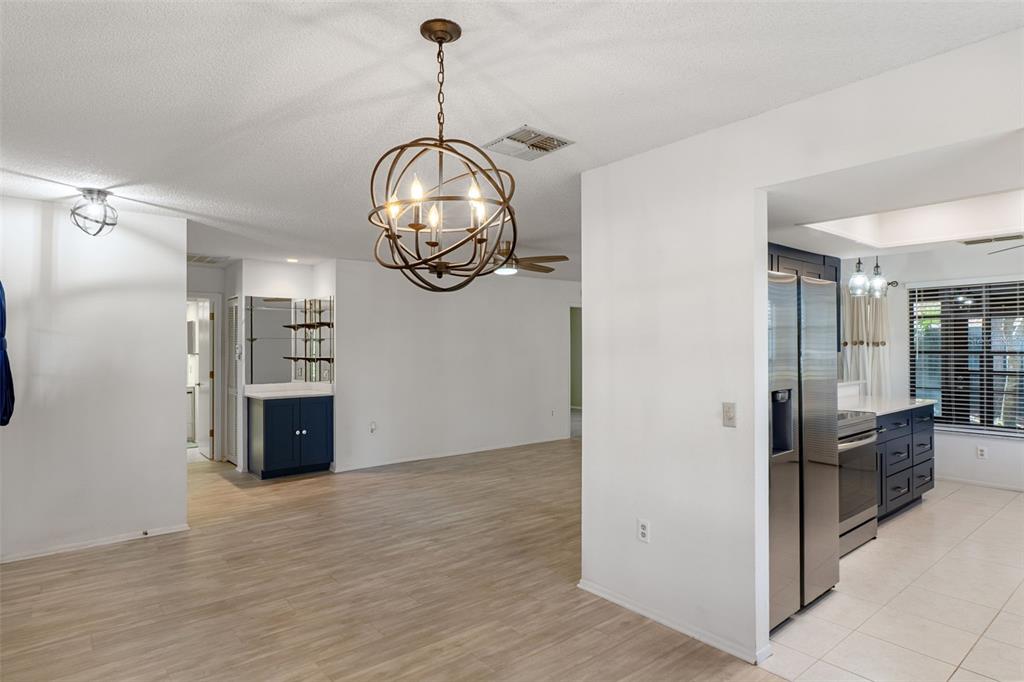 2129 Point O Woods Court Spring Hill, FL 34606 - Photo 8 of 76 a view of a livingroom with furniture wooden floor and chandelier