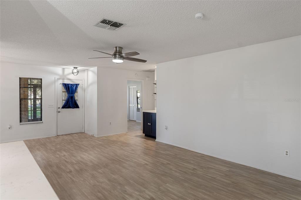 2129 Point O Woods Court Spring Hill, FL 34606 - Photo 9 of 76 wooden floor in an empty room with a window