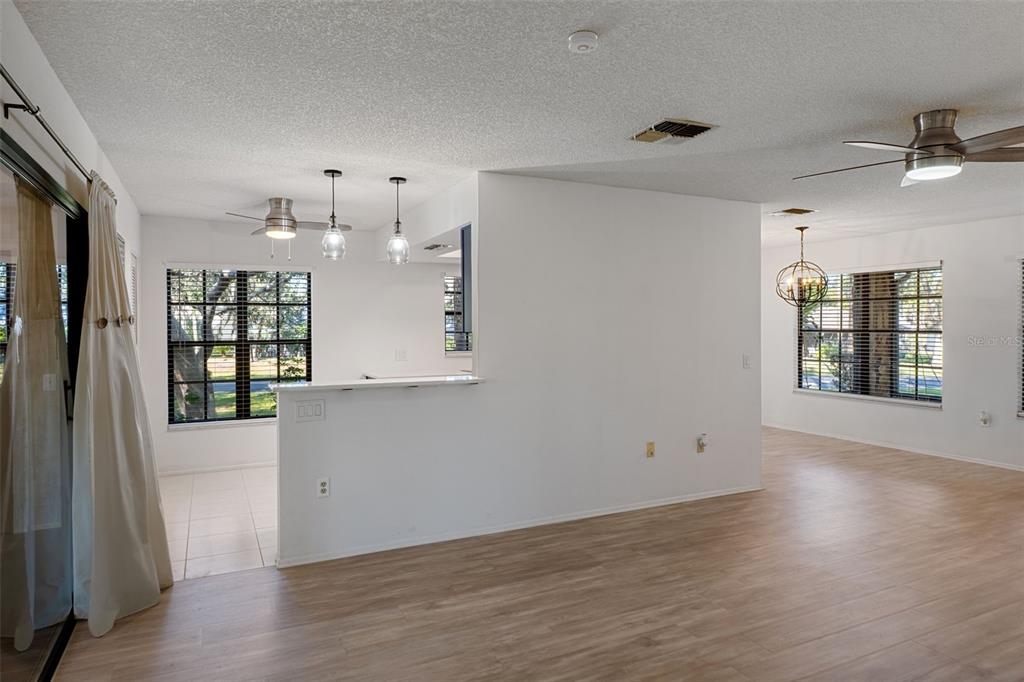 2129 Point O Woods Court Spring Hill, FL 34606 - Photo 10 of 76 an empty room with wooden floor and windows