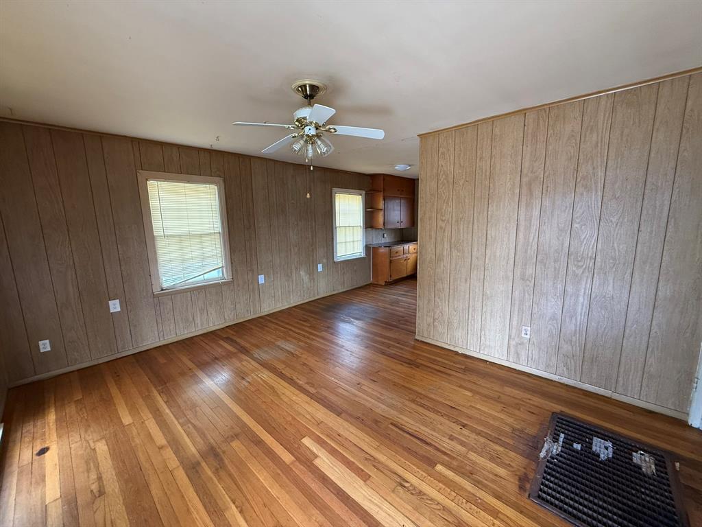 3211 North 25th Street Waco, TX 76708 - Photo 2 of 12 a view of an empty room with wooden floor and a window