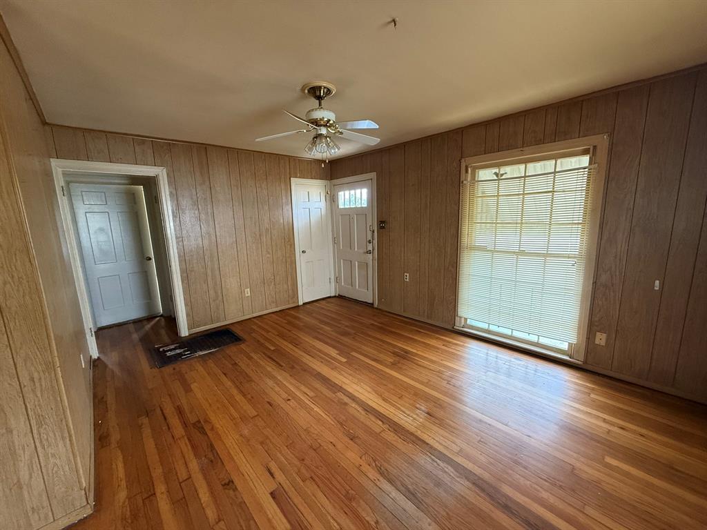 3211 North 25th Street Waco, TX 76708 - Photo 3 of 12 wooden floor in an empty room with a window