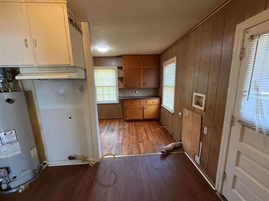3211 North 25th Street Waco, TX 76708 - Photo 8 of 12 a view of a kitchen with wooden floor and electronic appliances
