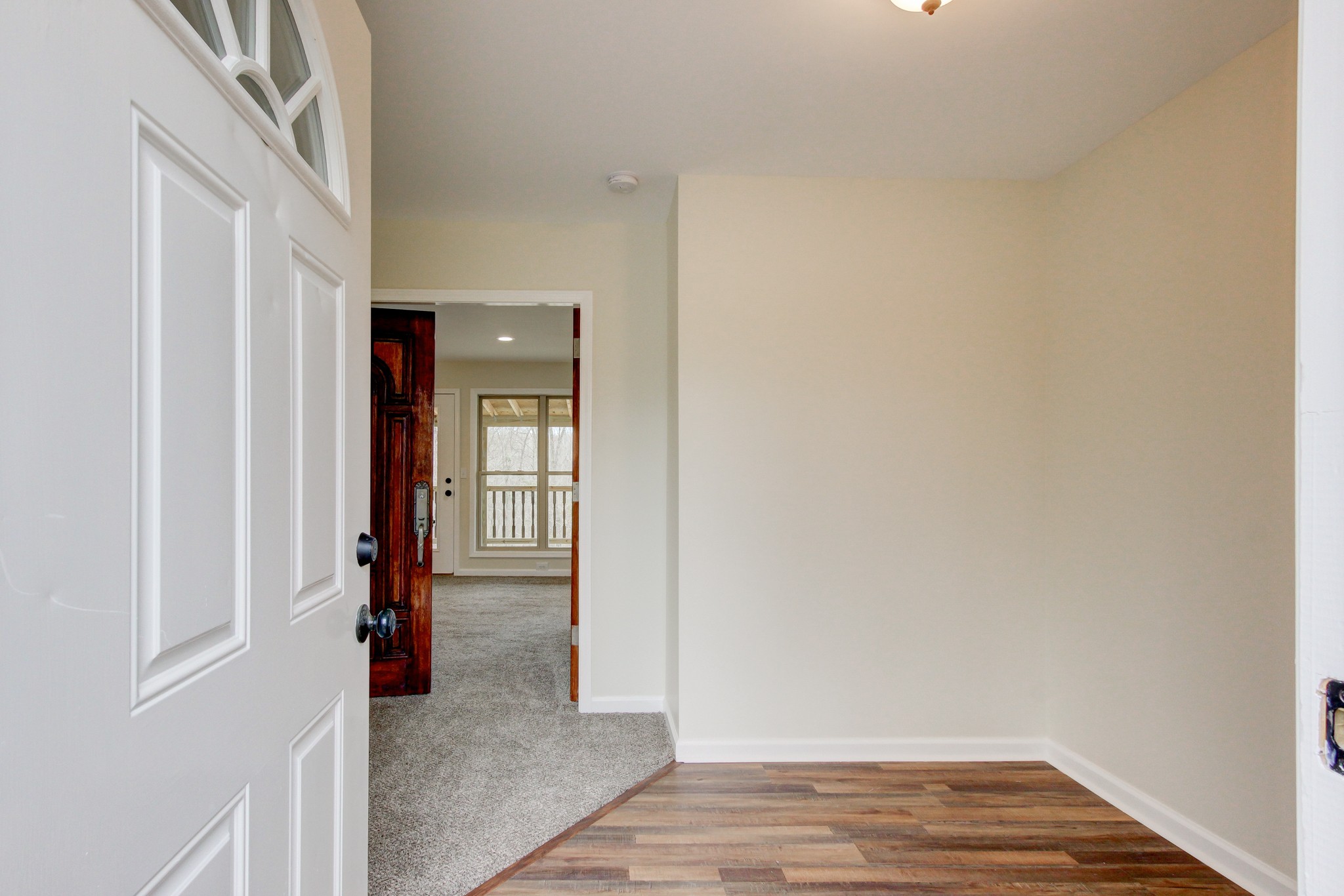 825 Pollard Road Clarksville, TN 37042 - Photo 7 of 44 a view of an empty room with wooden floor and a window