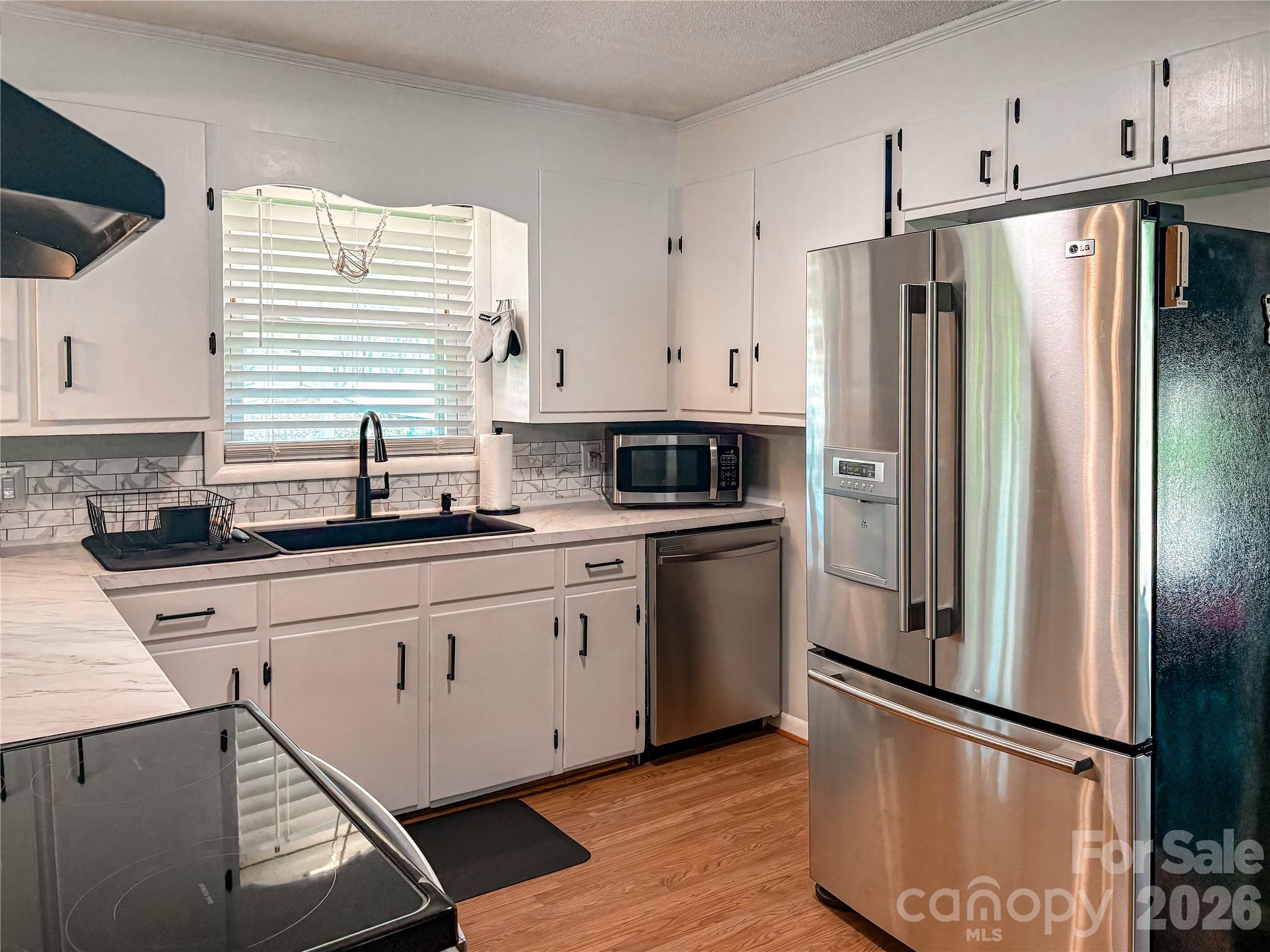 2011 Mountain Creek Road Albemarle, NC 28001 - Photo 11 of 27 a kitchen with stainless steel appliances a refrigerator sink and microwave