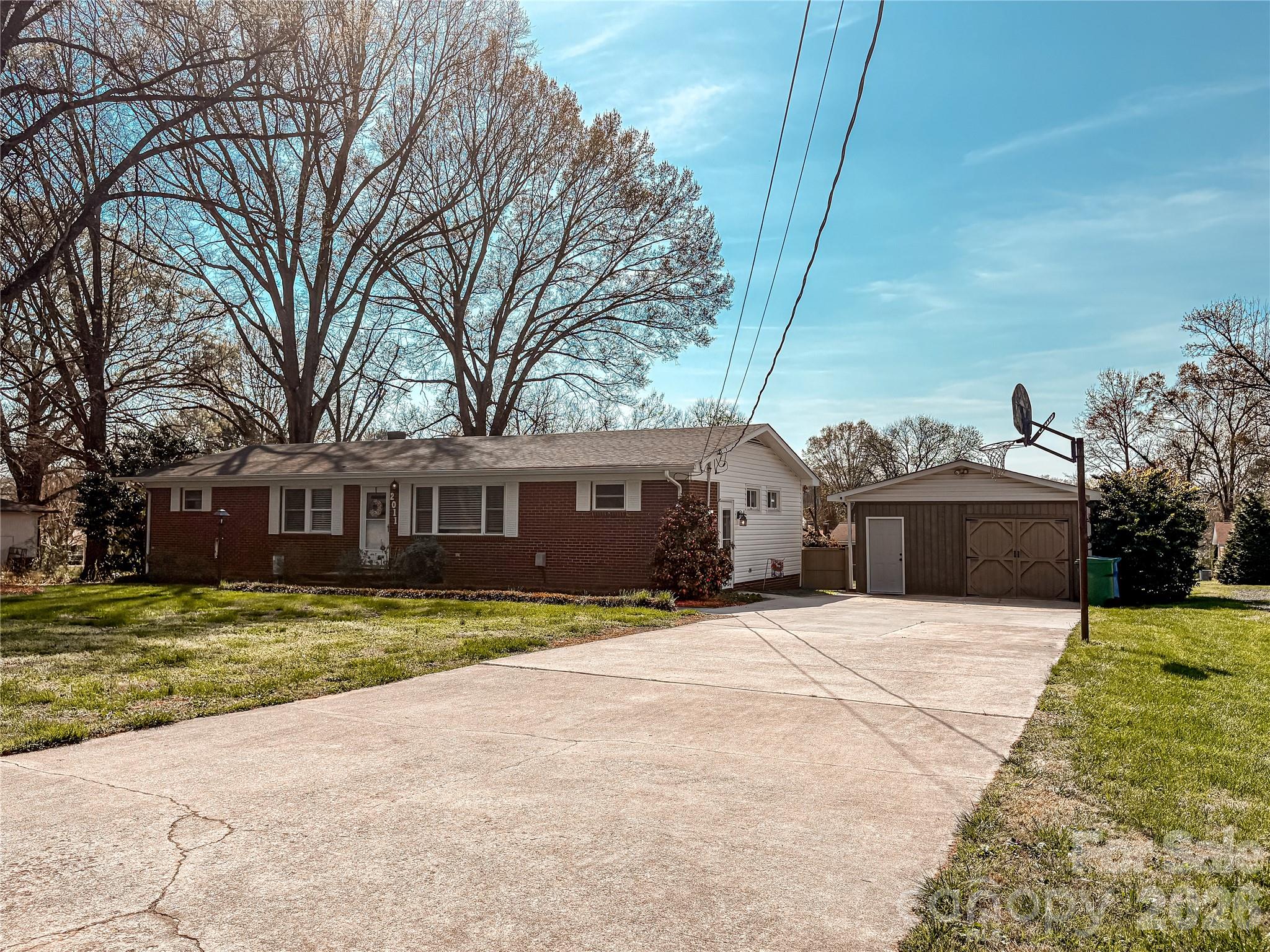 2011 Mountain Creek Road Albemarle, NC 28001 - Photo 2 of 27 a front view of a house with a garden and trees