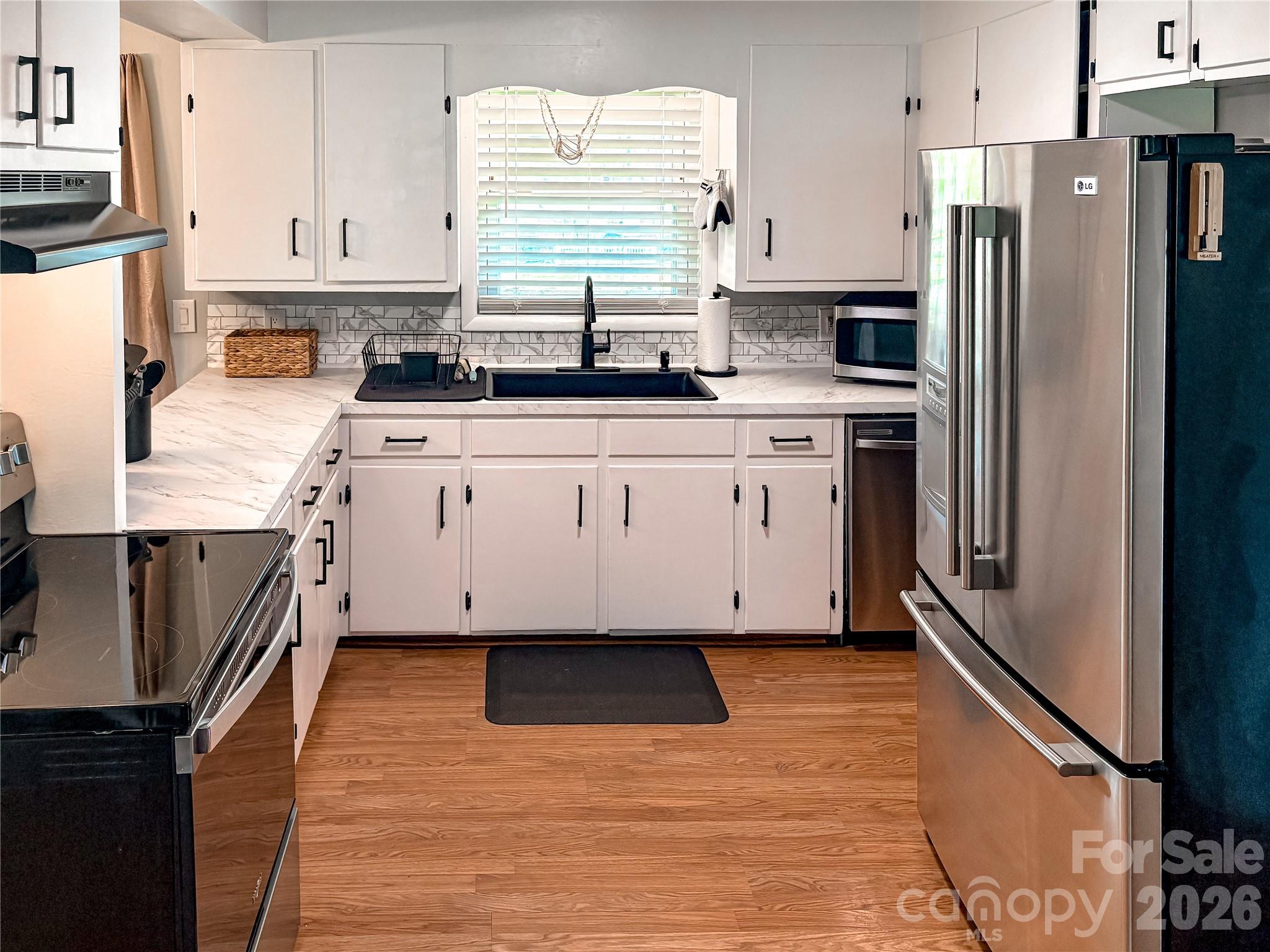2011 Mountain Creek Road Albemarle, NC 28001 - Photo 10 of 27 a kitchen with stainless steel appliances a refrigerator sink and cabinets