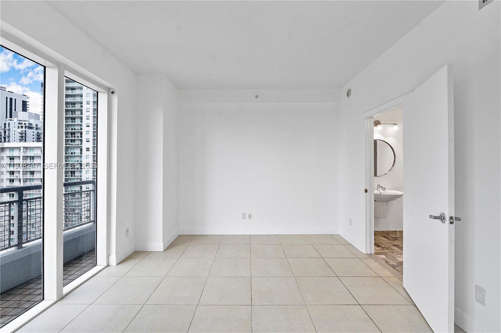 60 Southwest 13th Street, Unit 1921 Miami, FL 33130 - Photo 13 of 23 a view of an empty room with a window