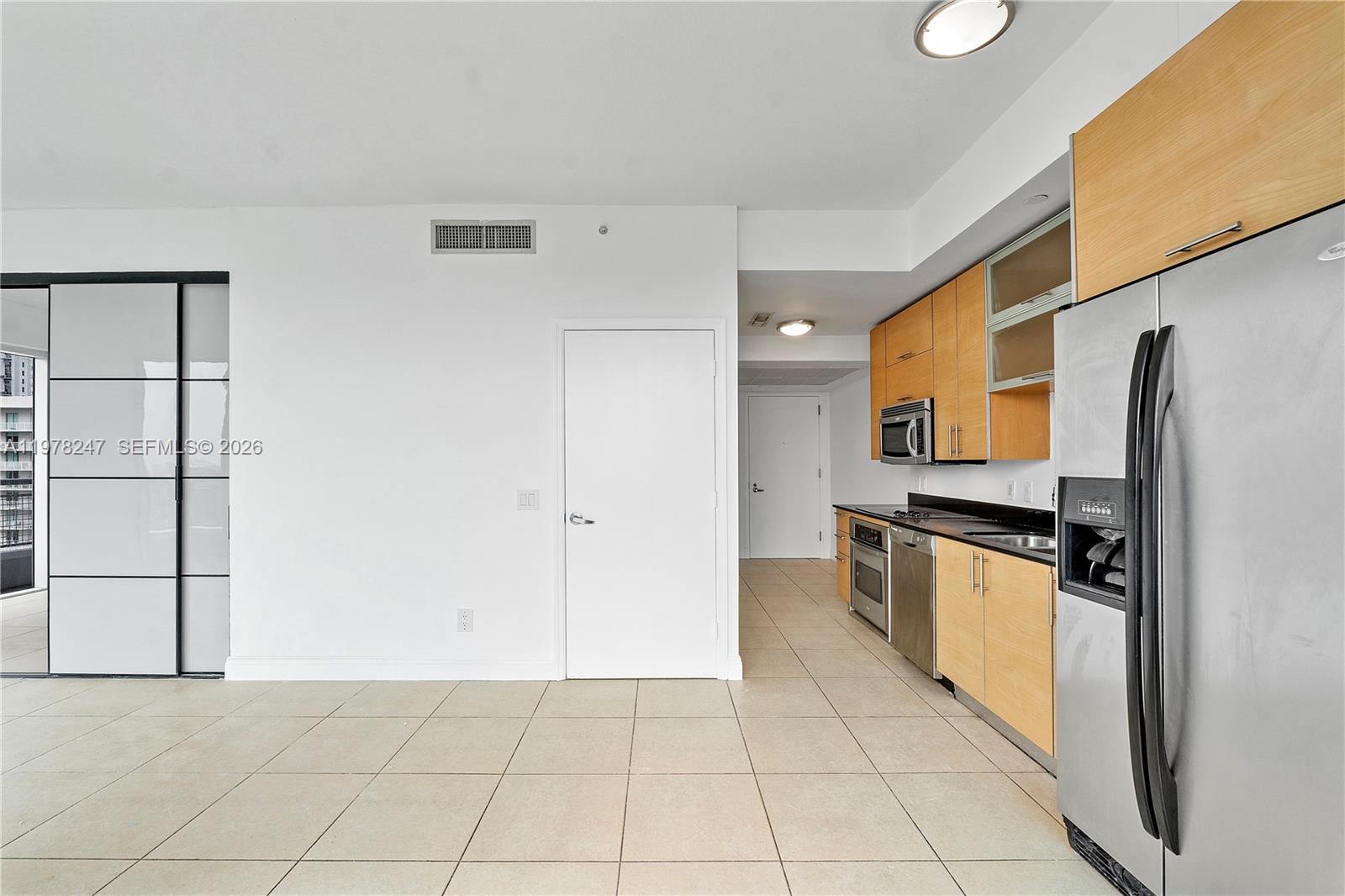 60 Southwest 13th Street, Unit 1921 Miami, FL 33130 - Photo 14 of 23 a kitchen with stainless steel appliances granite countertop a refrigerator and a stove