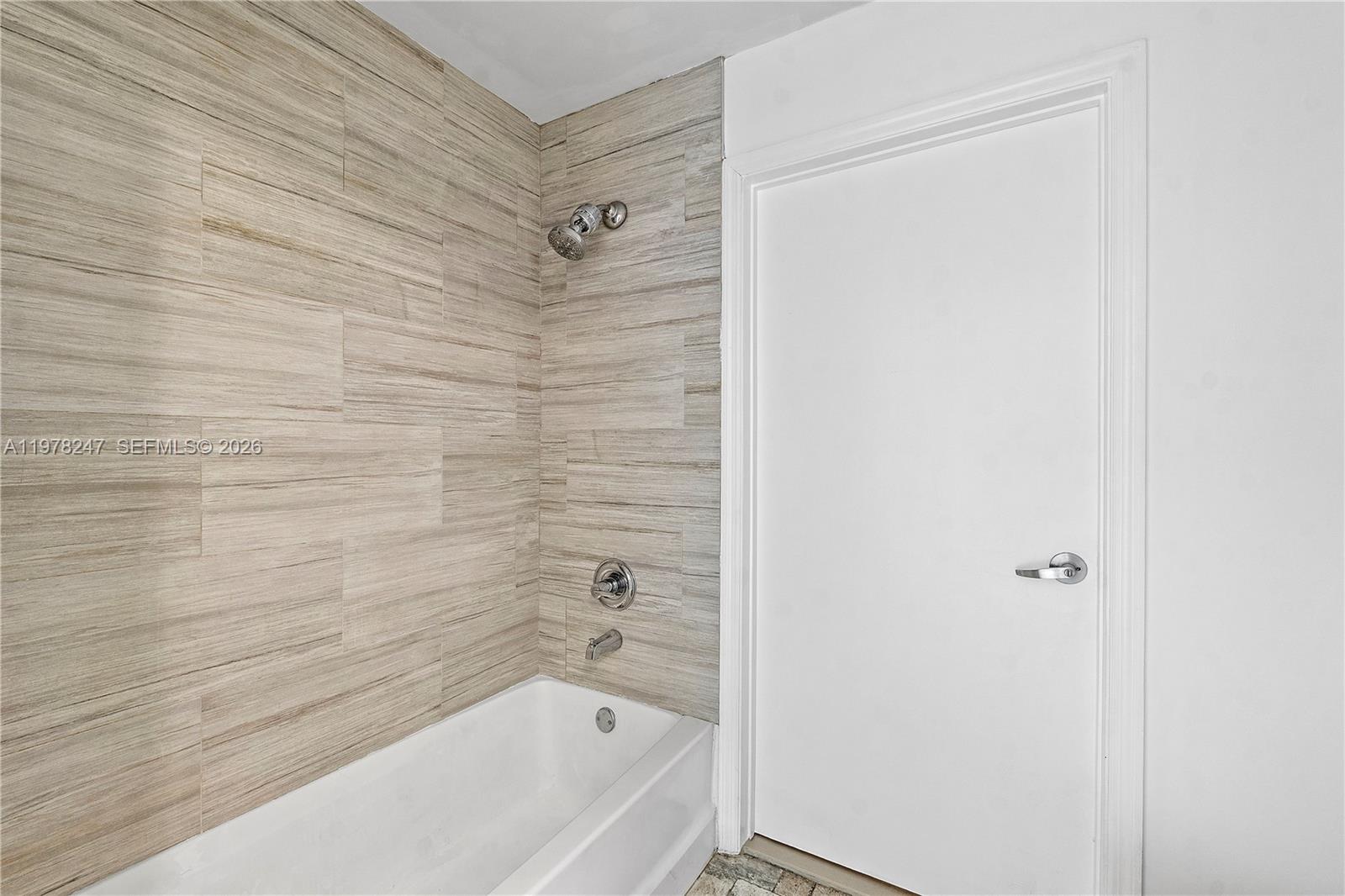 60 Southwest 13th Street, Unit 1921 Miami, FL 33130 - Photo 17 of 23 a bathroom with a bathtub