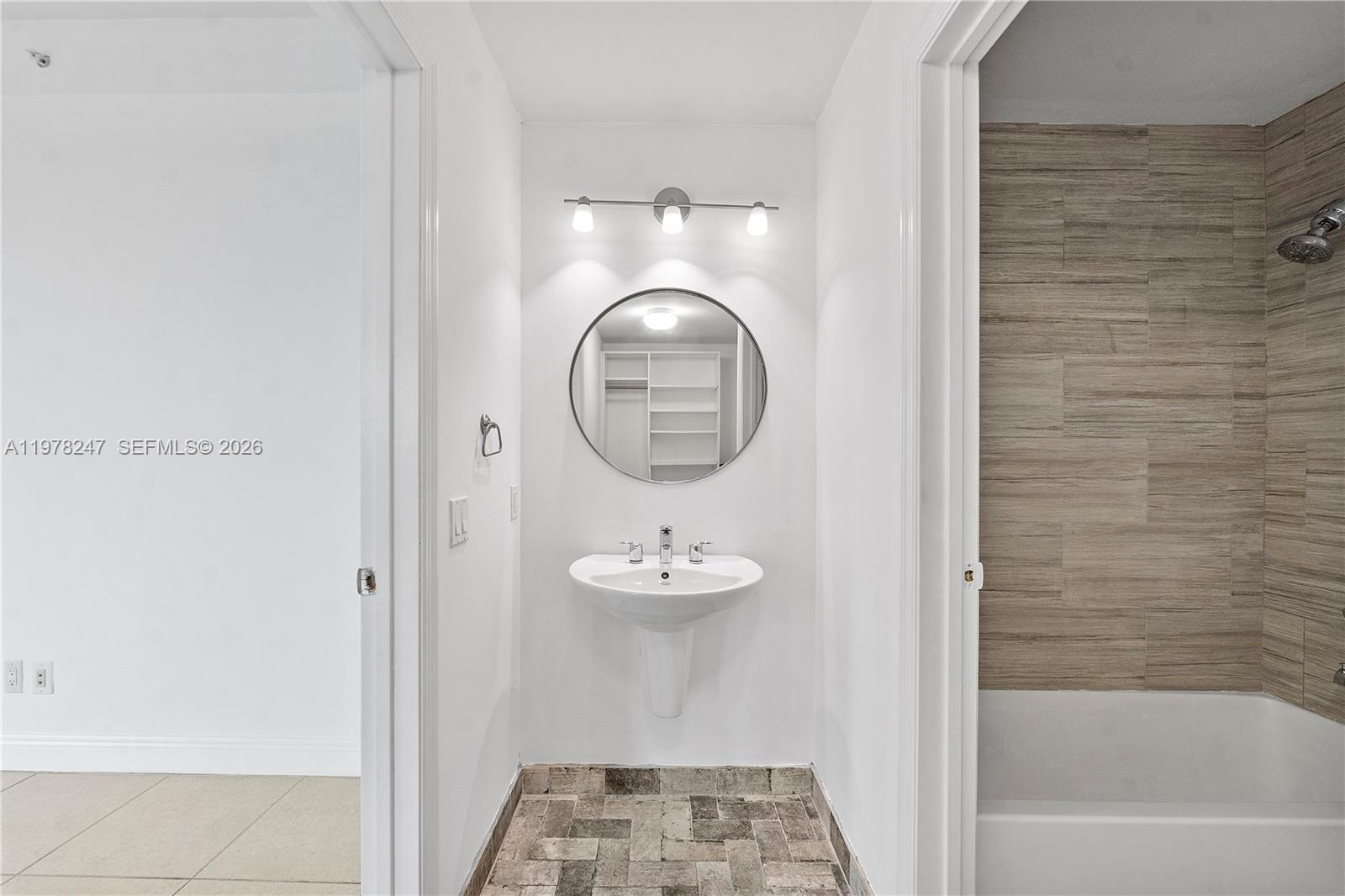 60 Southwest 13th Street, Unit 1921 Miami, FL 33130 - Photo 18 of 23 a bathroom with a sink and a mirror
