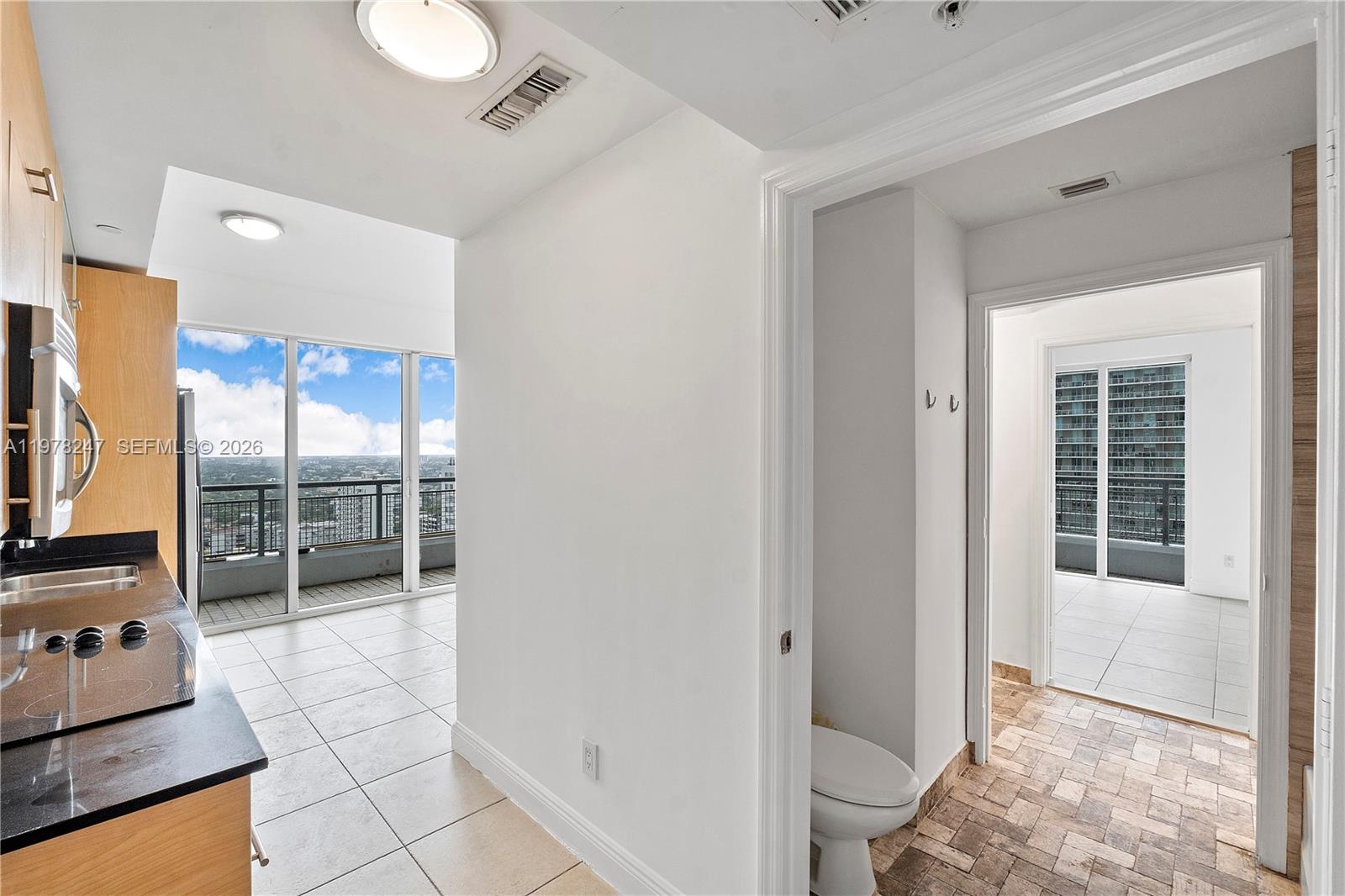 60 Southwest 13th Street, Unit 1921 Miami, FL 33130 - Photo 23 of 23 a room with a large window and flat screen tv