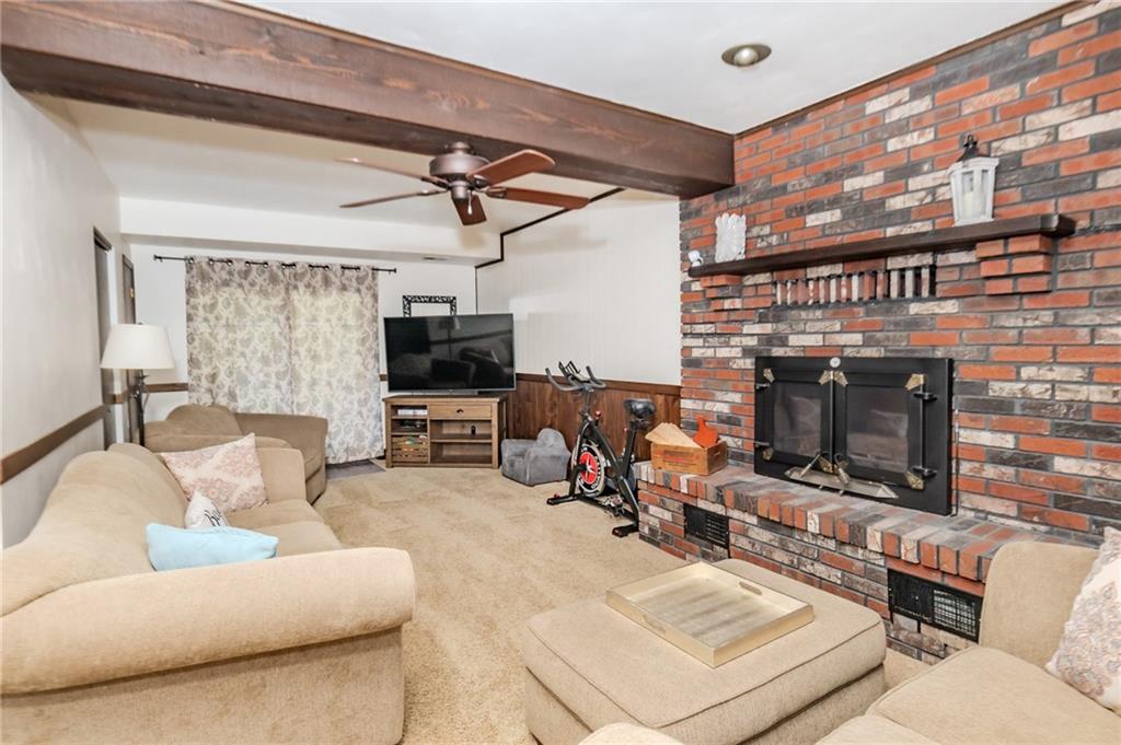 2229 Ramsey Road Monroeville, PA 15146 - Photo 14 of 40 a living room with furniture a flat screen tv and a fireplace