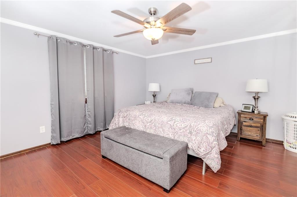 2229 Ramsey Road Monroeville, PA 15146 - Photo 16 of 40 a spacious bedroom with a bed and a chandelier