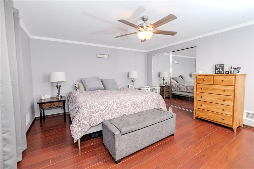 2229 Ramsey Road Monroeville, PA 15146 - Photo 17 of 40 a bedroom with a bed a dresser and a chandelier