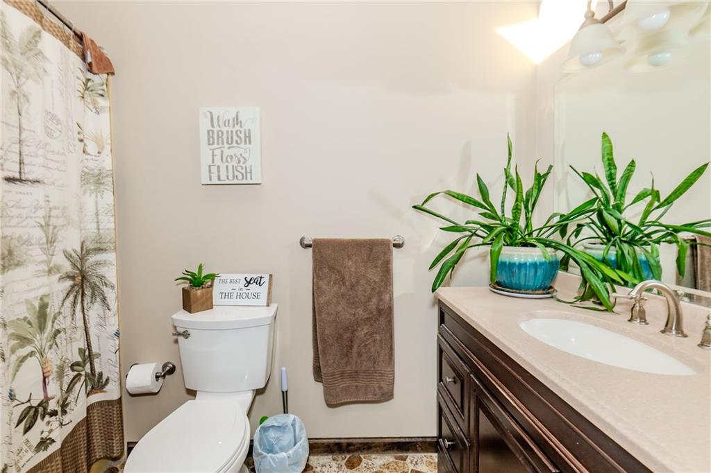 2229 Ramsey Road Monroeville, PA 15146 - Photo 22 of 40 a bathroom with a toilet a sink and a shower curtain