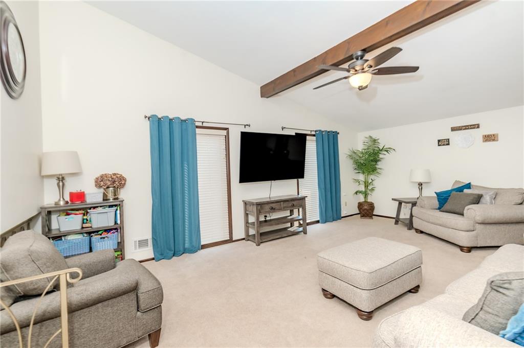 2229 Ramsey Road Monroeville, PA 15146 - Photo 7 of 40 a living room with furniture a flat screen tv and a floor to ceiling window