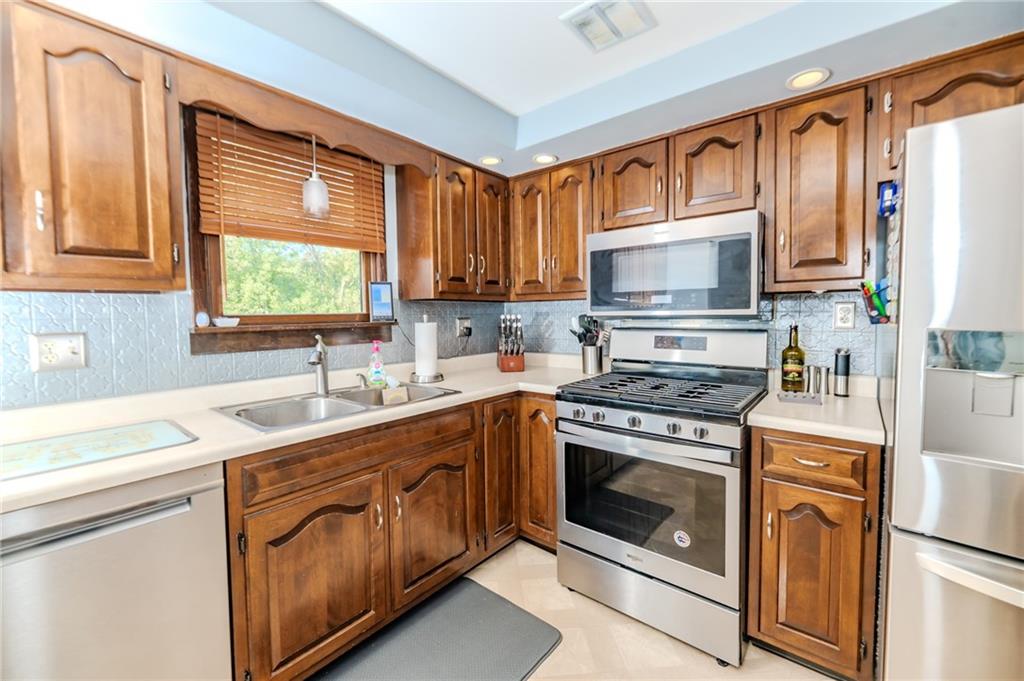 2229 Ramsey Road Monroeville, PA 15146 - Photo 10 of 40 a kitchen with a stove a sink and a microwave