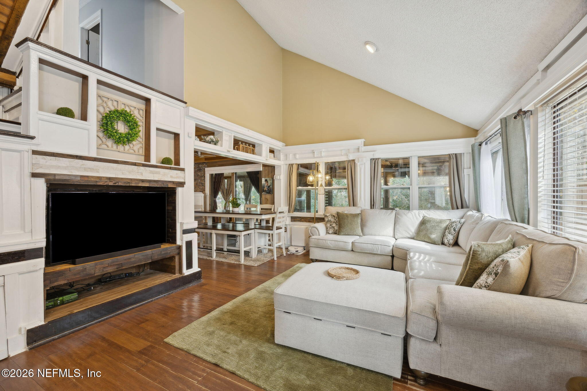 2431 Cypress Springs Road Orange Park, FL 32073 - Photo 21 of 83 a living room with furniture a flat screen tv and a fireplace