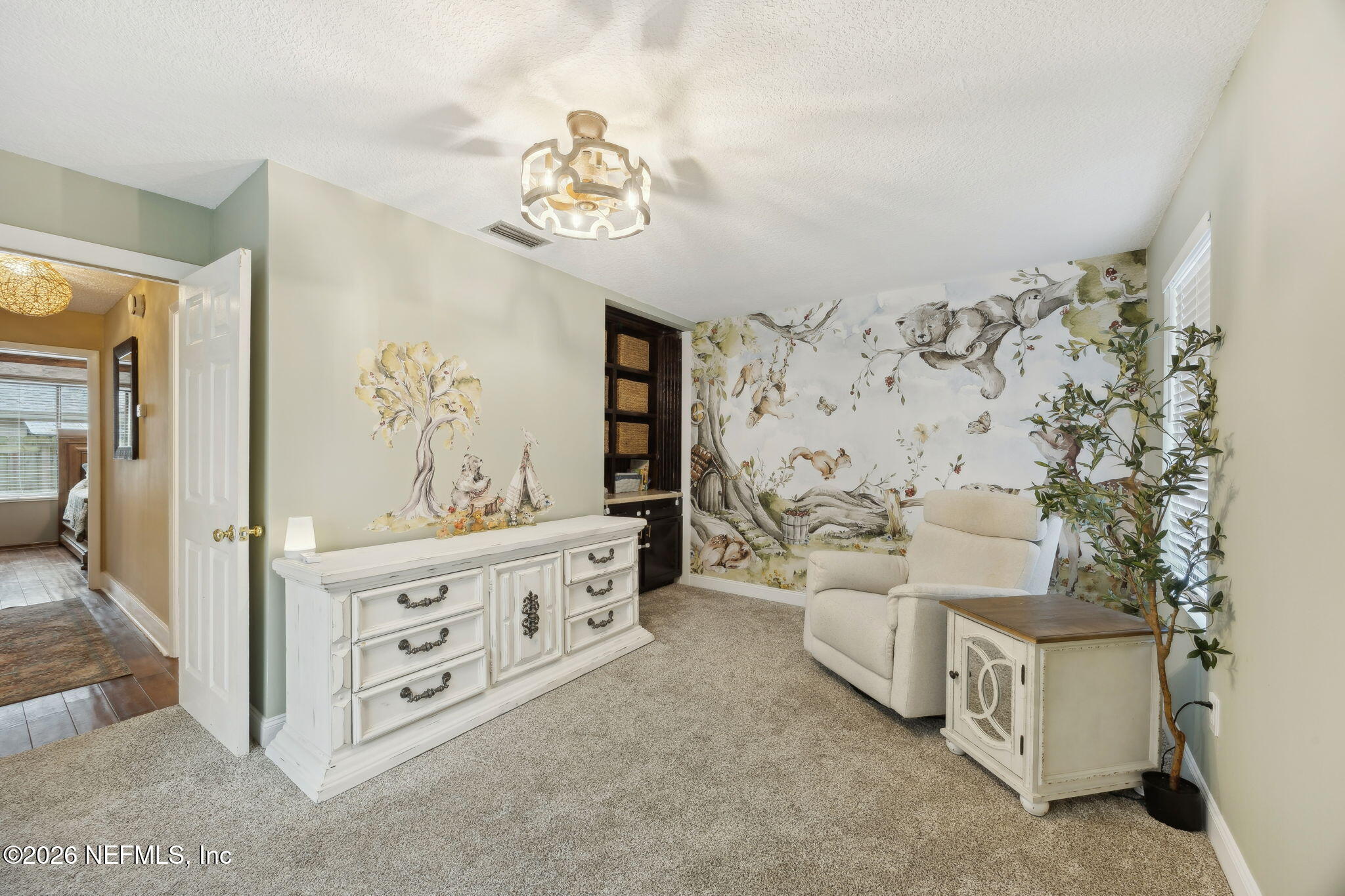 2431 Cypress Springs Road Orange Park, FL 32073 - Photo 25 of 83 a spacious bedroom with a bed and a chandelier