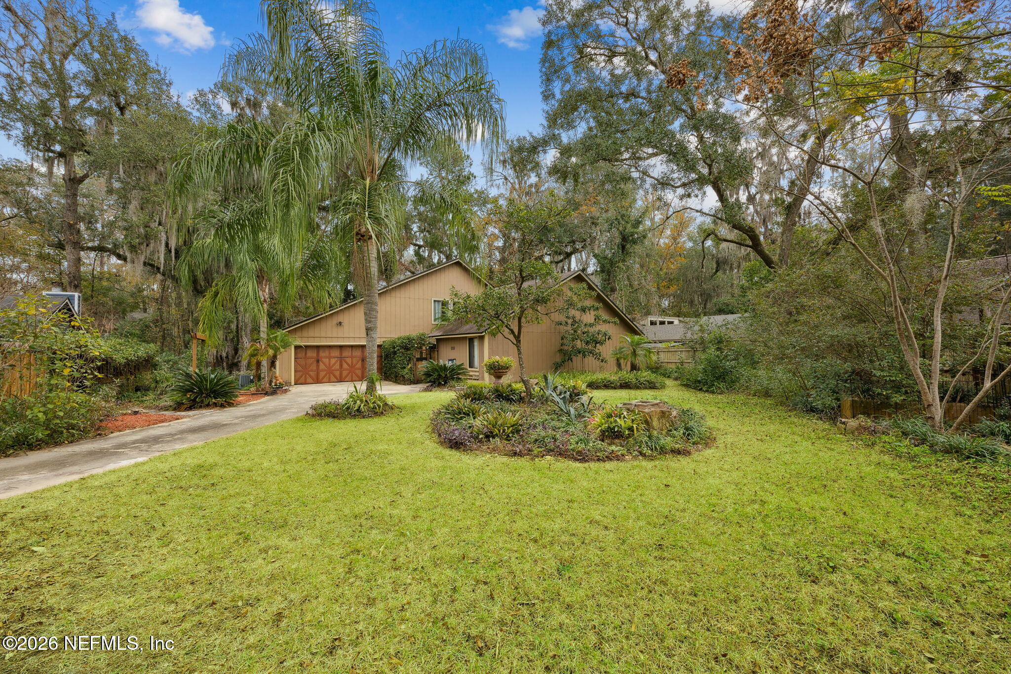 2431 Cypress Springs Road Orange Park, FL 32073 - Photo 5 of 83 a yellow house with trees in front of it